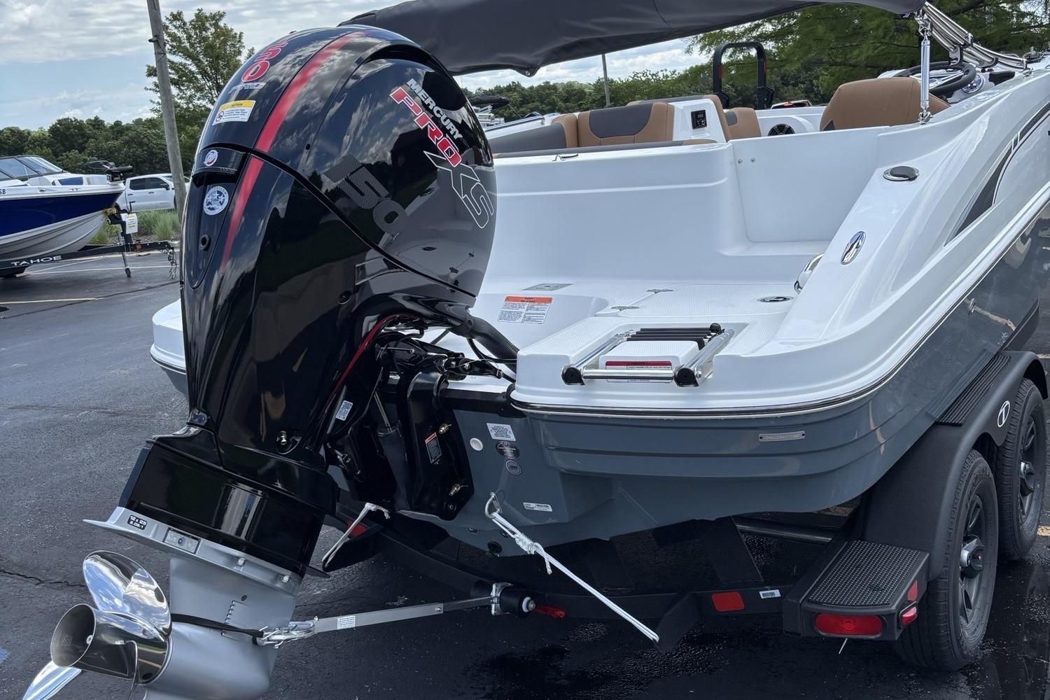 2026 Tahoe 1950 boat with powerful outboard motor, parked on a trailer.