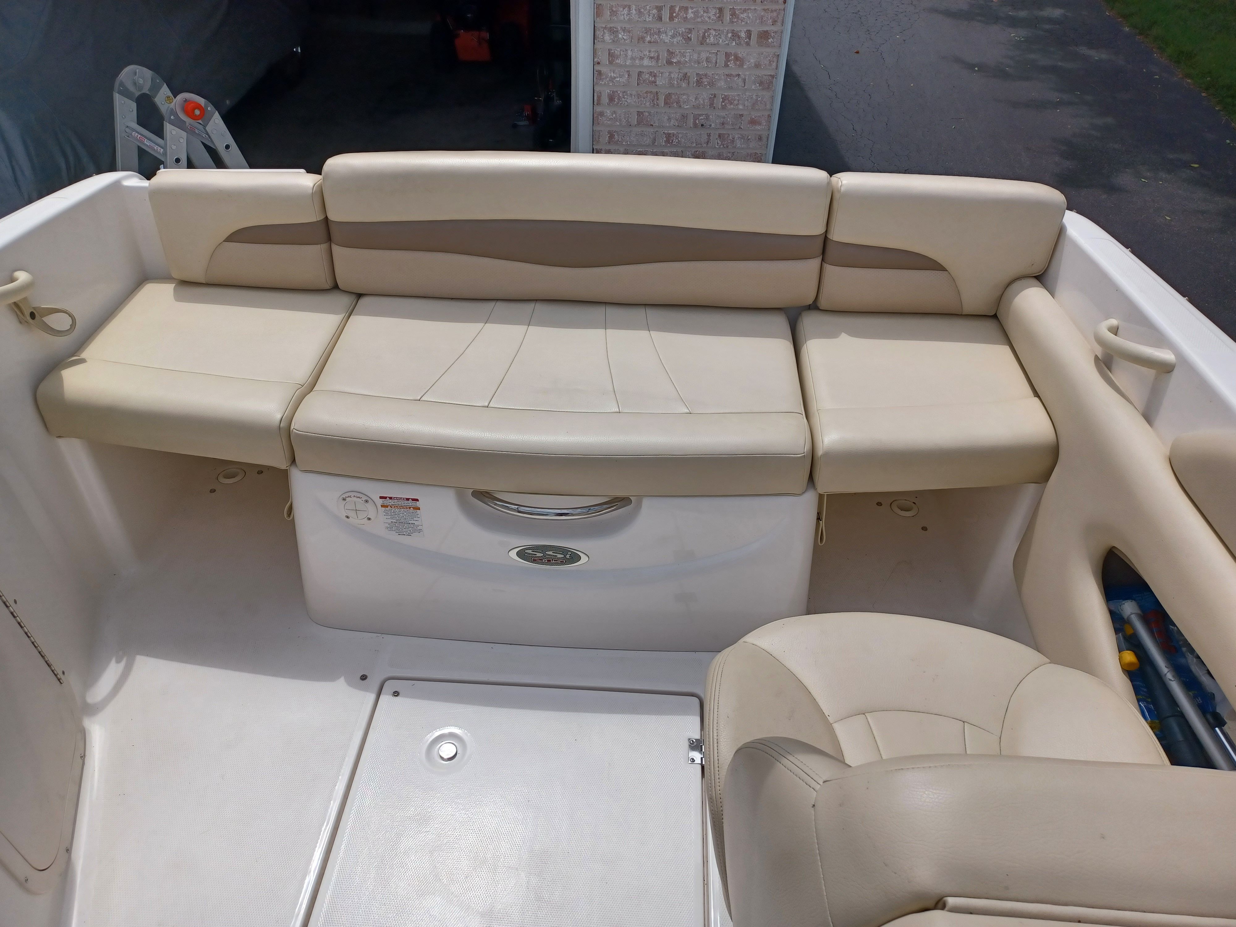 The image shows the seating area of a 2004 Chaparral 215 SSi boat with beige upholstery.
