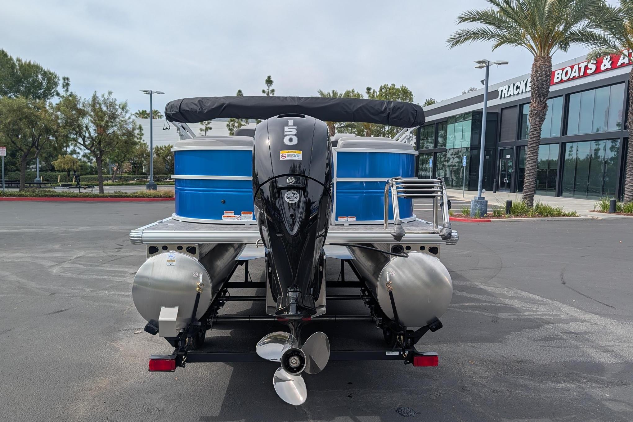 2026 Sun Tracker Party Barge 22 DLX pontoon boat with powerful outboard motor.
