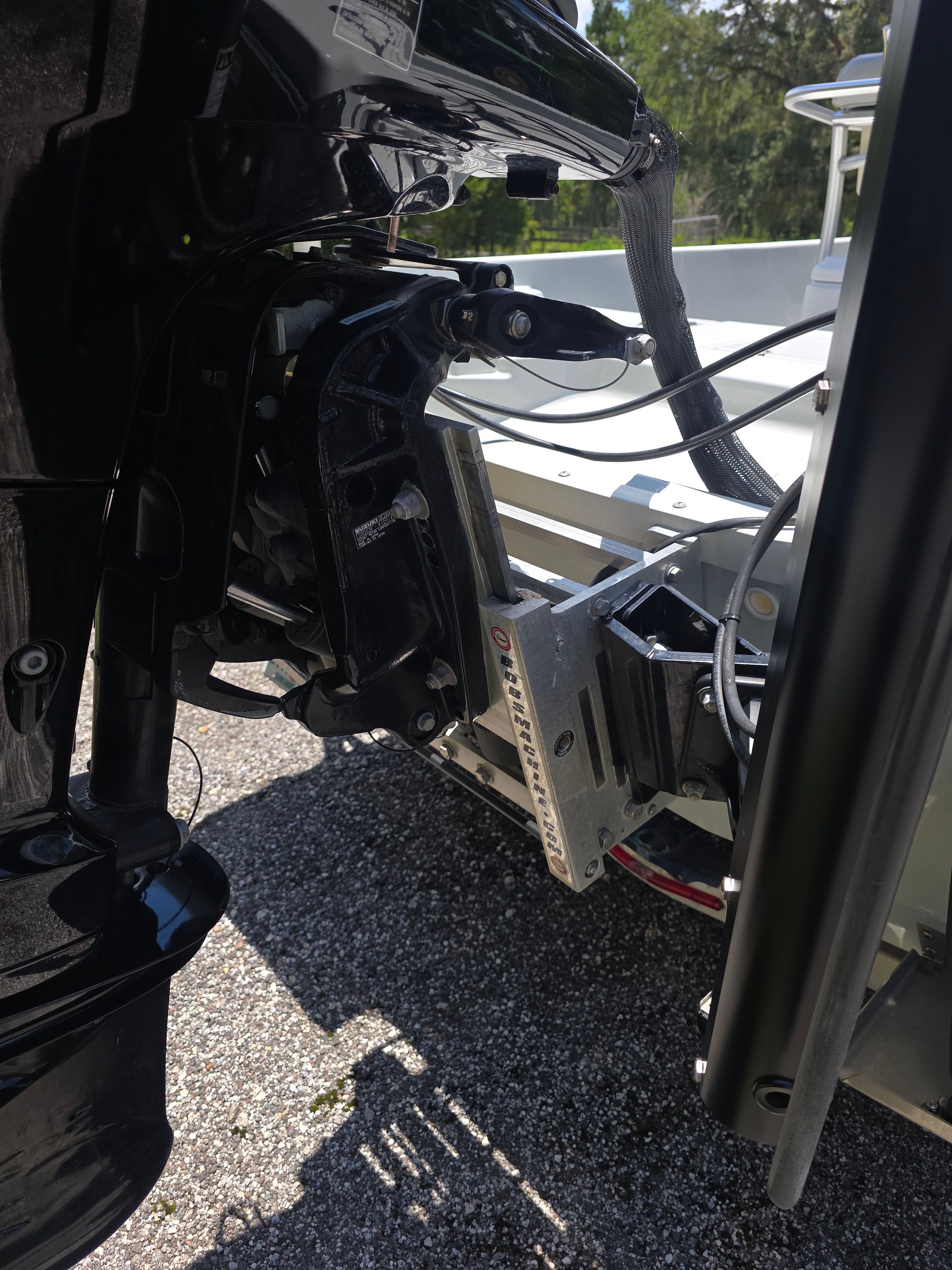 Close-up of a boat's outboard motor and its mounting bracket.