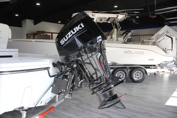 2025 East Cape 25 Open boat with Suzuki outboard motor in showroom.