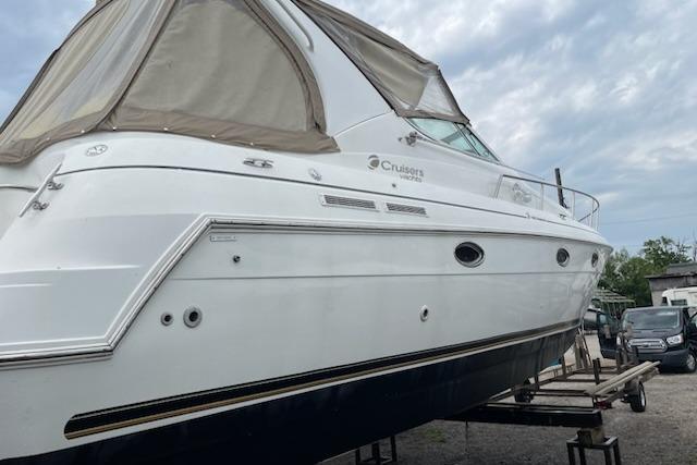 2002 Cruisers Yachts 3372 Express boat on dry dock, side view.