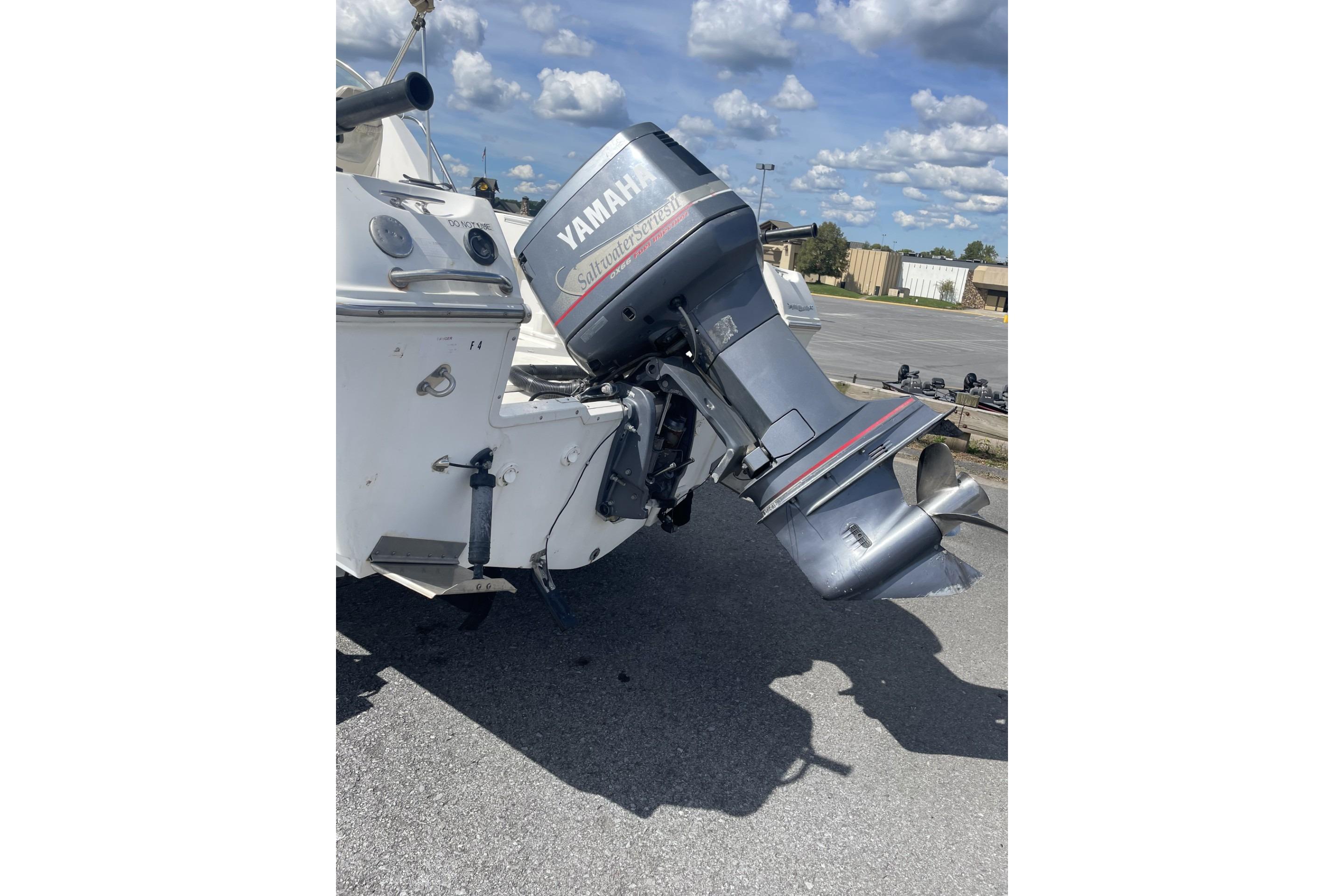 2002 Wellcraft 24 Walkaround with Yamaha outboard motor in parking lot.
