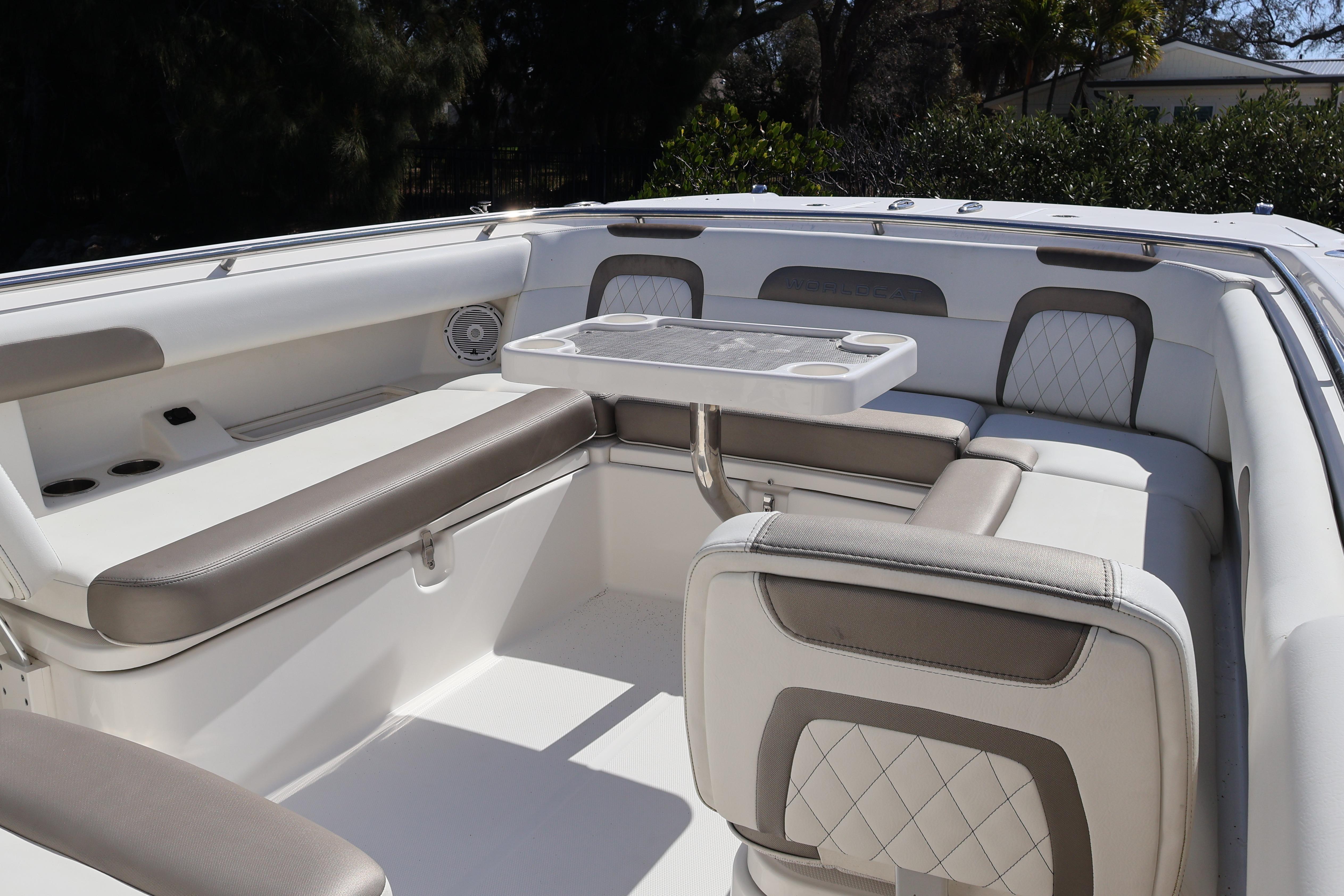 2022 World Cat 280 CC-X boat interior with cushioned seating and table.