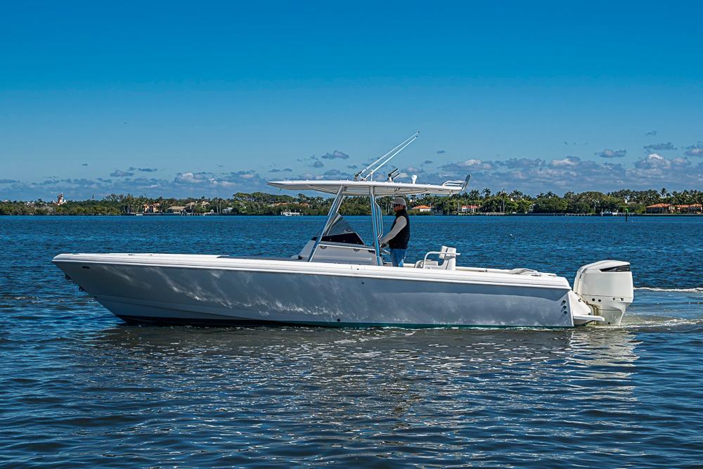2005 Intrepid 300 Center Console boat cruising on a sunny day.