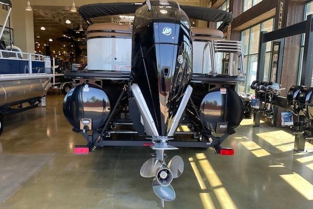 2026 Regency 230 DL pontoon boat with powerful outboard motor in showroom.