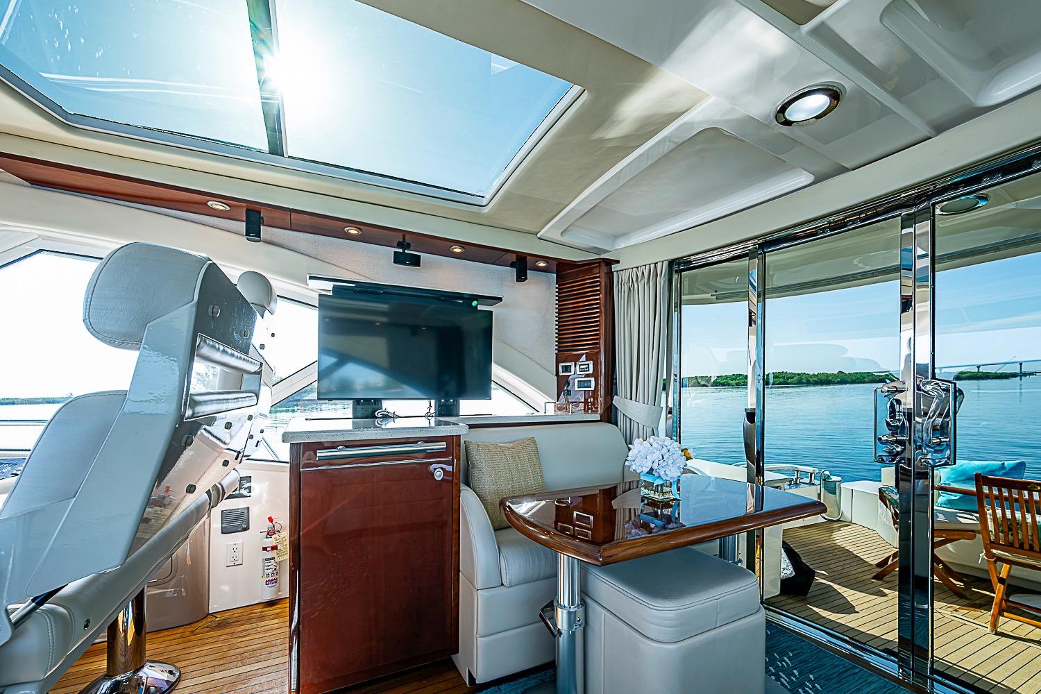 Luxurious interior of 2008 Sea Ray 60 Sundancer yacht with panoramic views and elegant furnishings.