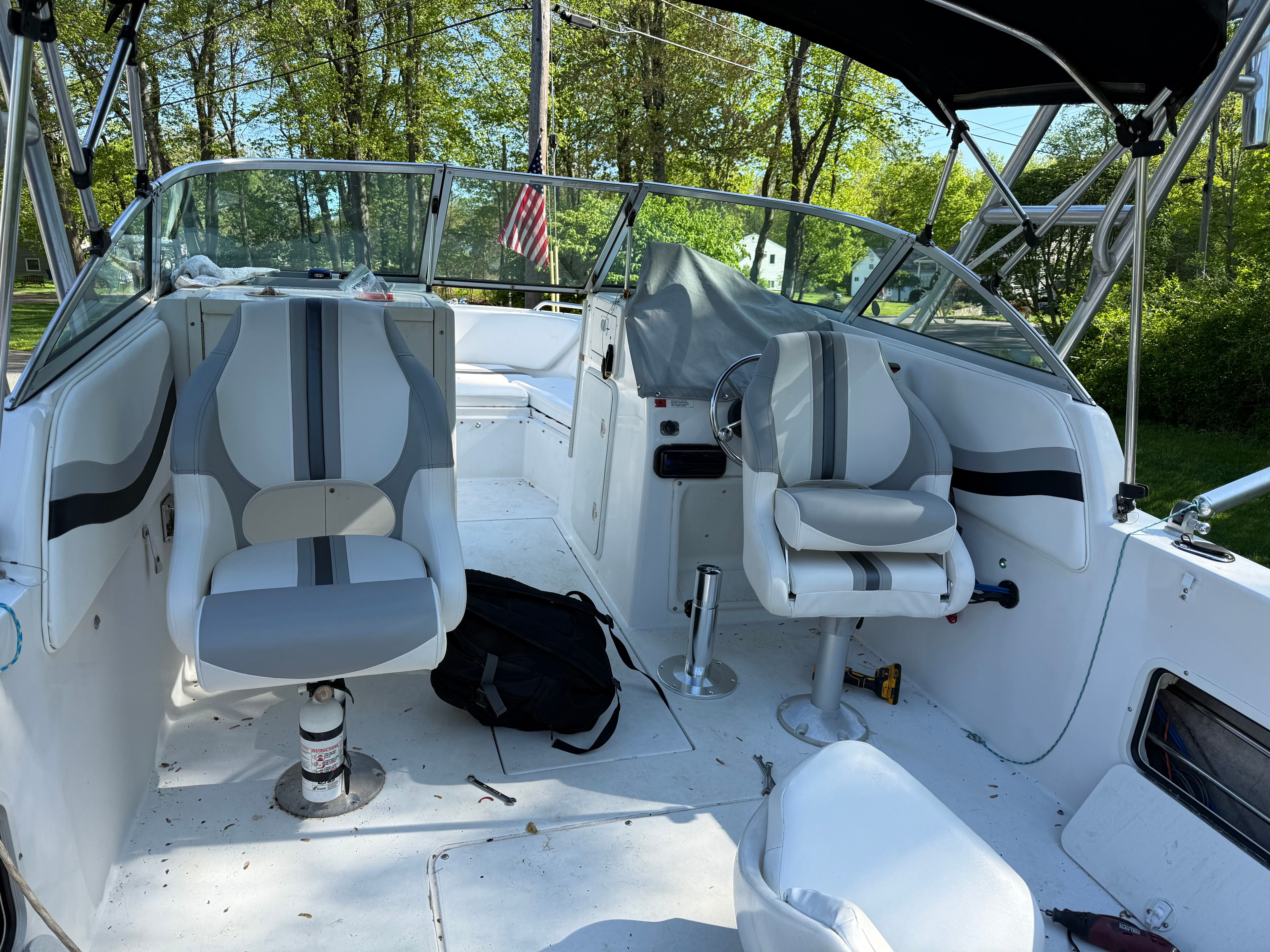 The image shows the cockpit of a 2002 Seaswirl Striper 2101 DC with two gray seats.