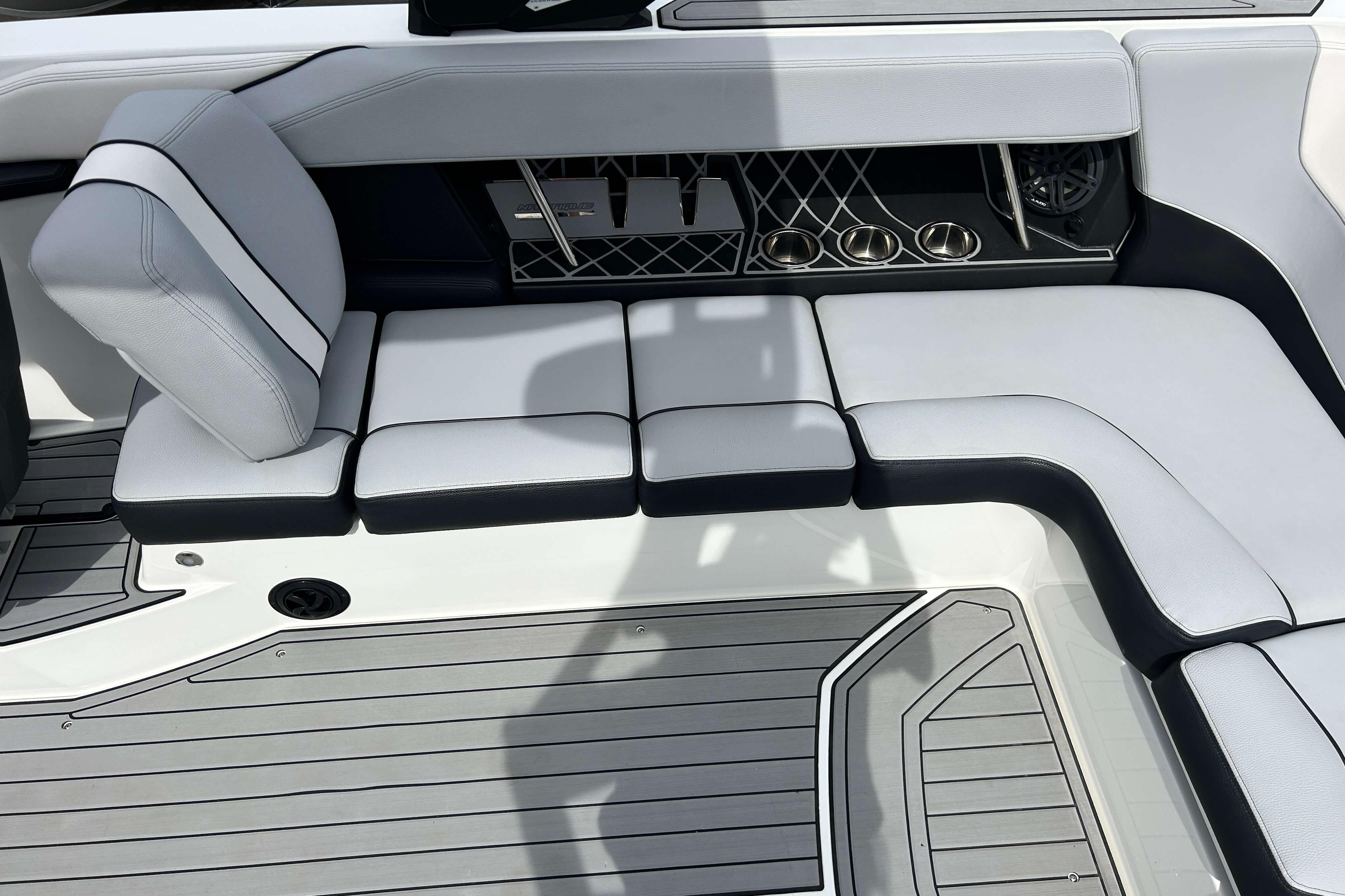 2021 Nautique Super Air Nautique GS24 interior seating with sleek design and cup holders.