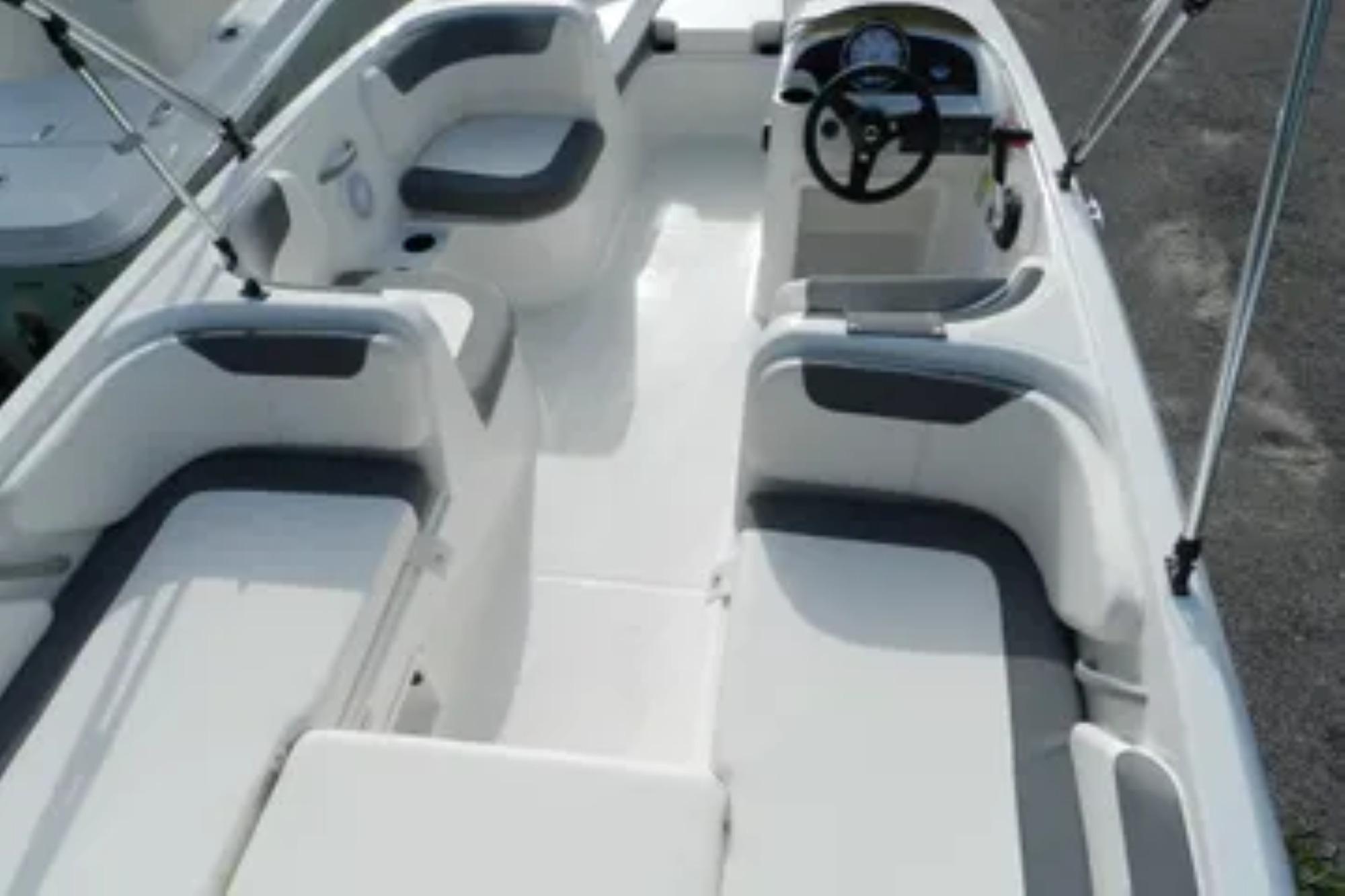2026 Bayliner Element E18 boat interior with seating and steering wheel.