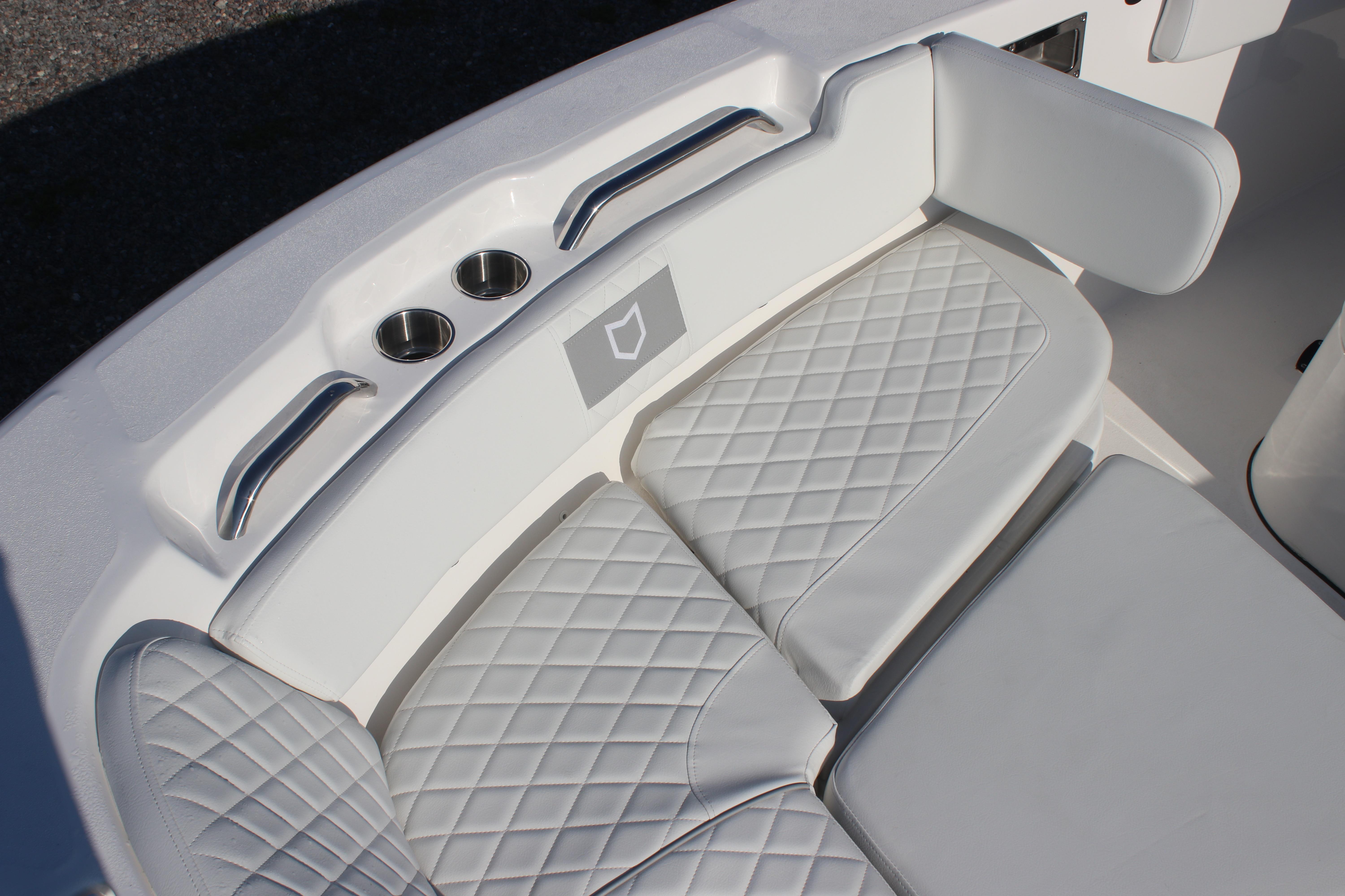 2026 Sea Fox 248 Commander boat seating with quilted cushions and cup holders.