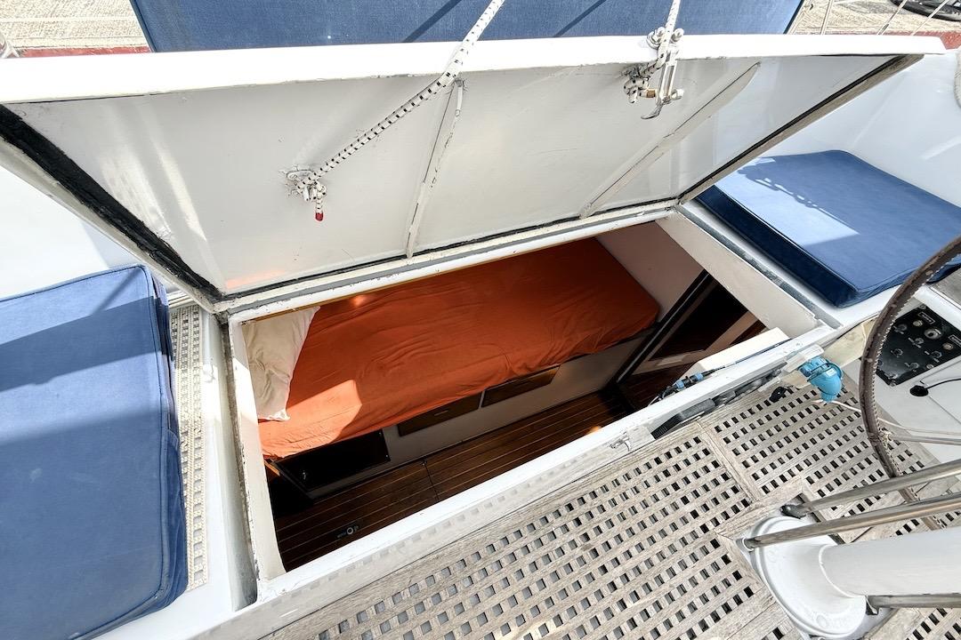 1973 Sparkman & Stephens 55 Custom ketch cabin with orange bedding and open hatch.
