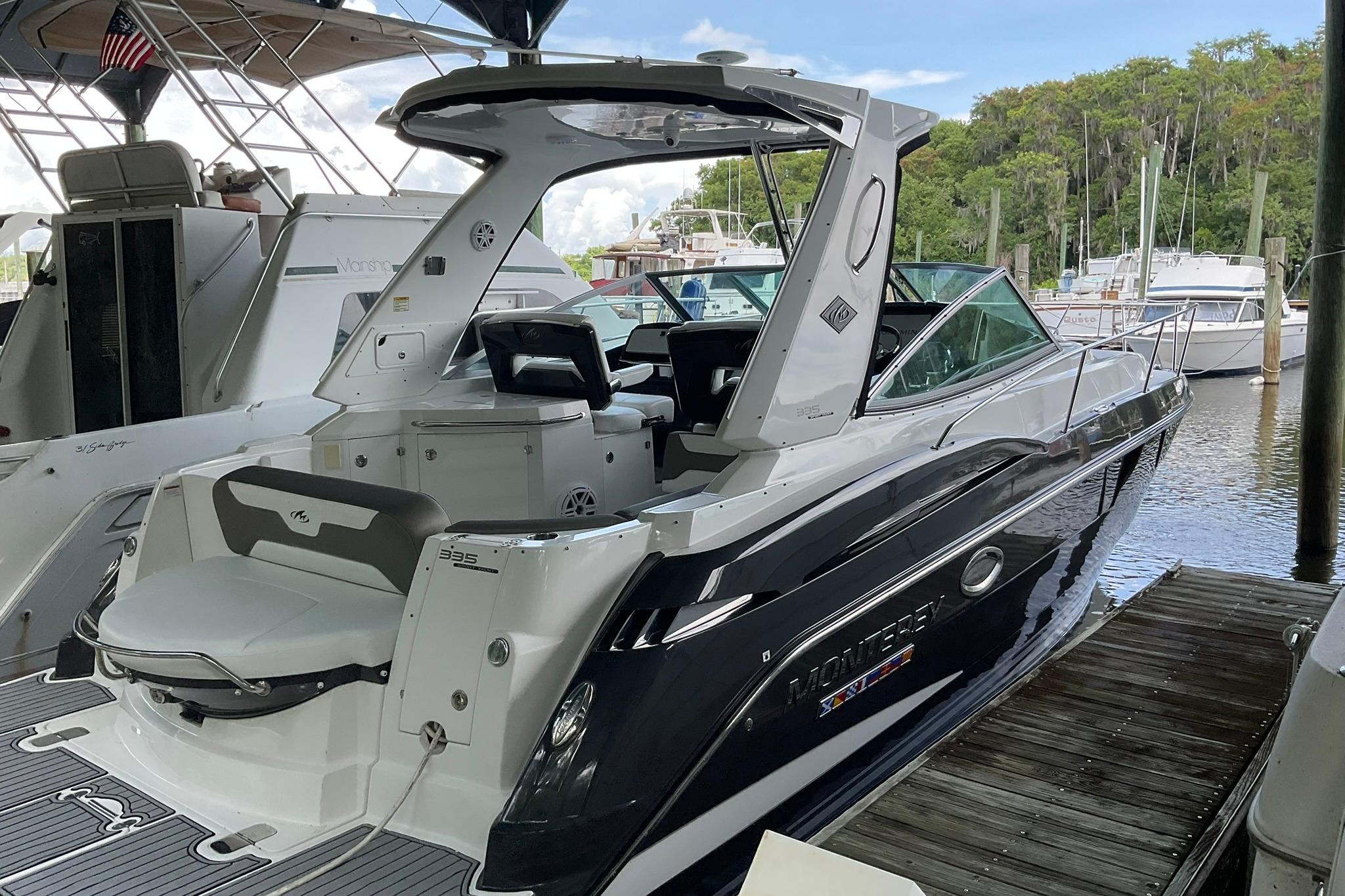 2019 Monterey 335 Sport Yacht docked at marina, showcasing sleek design and modern features.