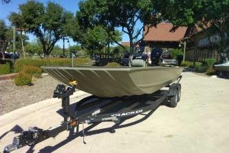 2026 Tracker Grizzly 2072 CC boat on trailer in sunny outdoor setting.