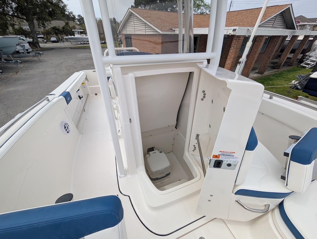 2025 Robalo R222 Explorer boat interior with open storage compartment and seating.