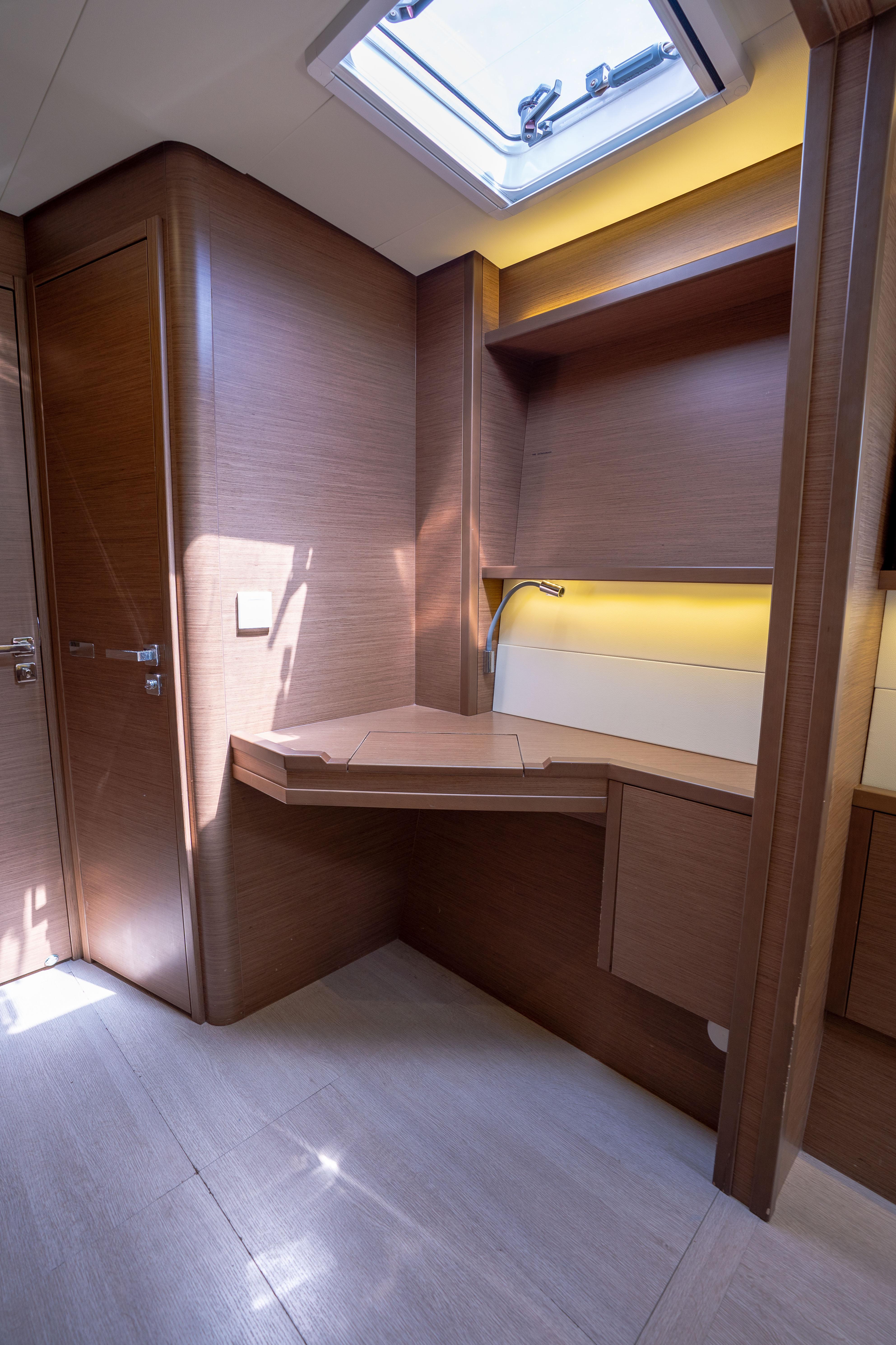 Interior of 2018 Lagoon 52 F yacht with wooden cabinetry and skylight.
