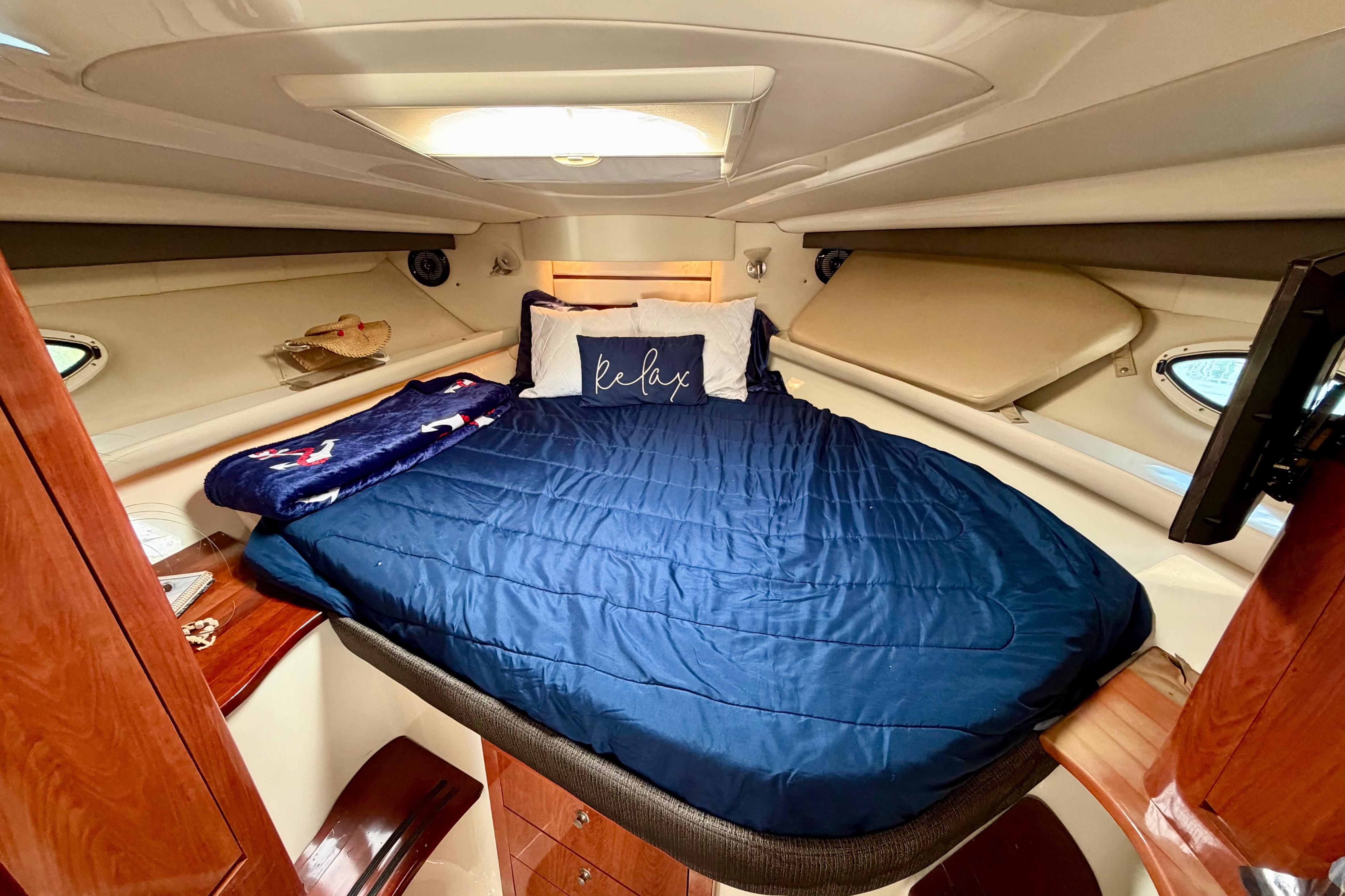 Luxurious cabin interior of 2007 Monterey 350 Sport Yacht with cozy bedding.