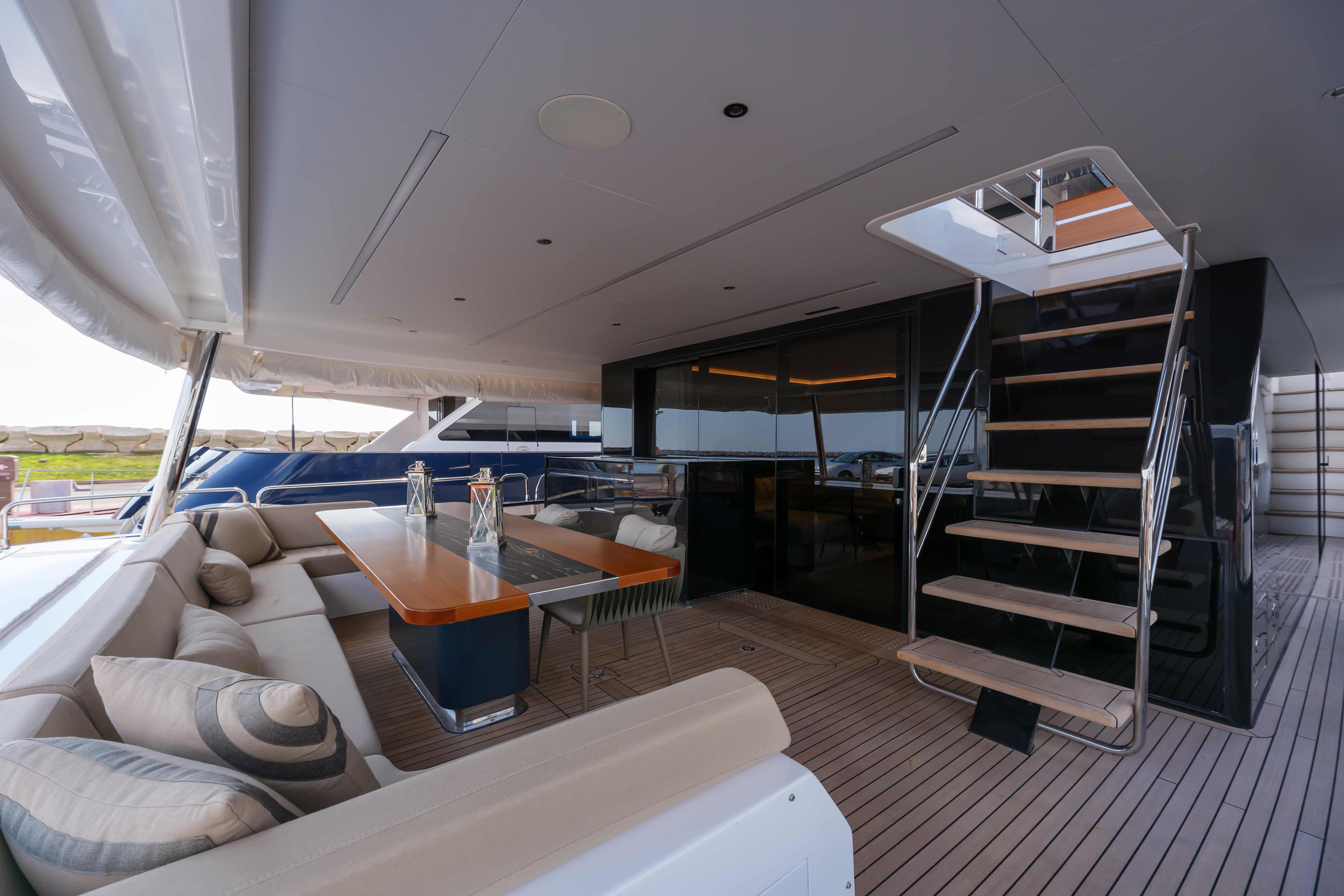 Luxurious 2024 Sirena 88 yacht deck with elegant seating and modern staircase.
