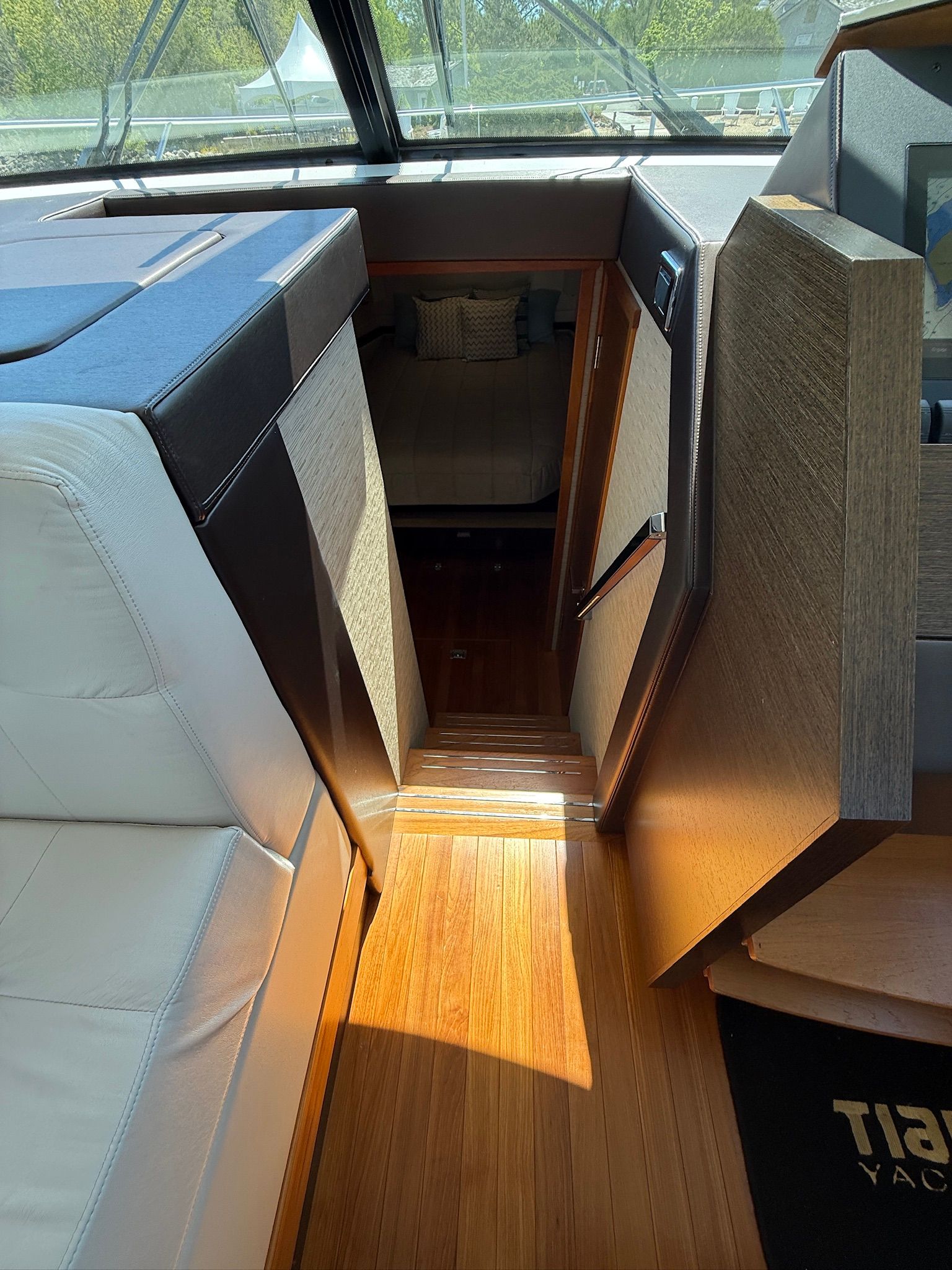 Interior of the Tiara Yachts C44 Coupe with wooden flooring and white upholstery.