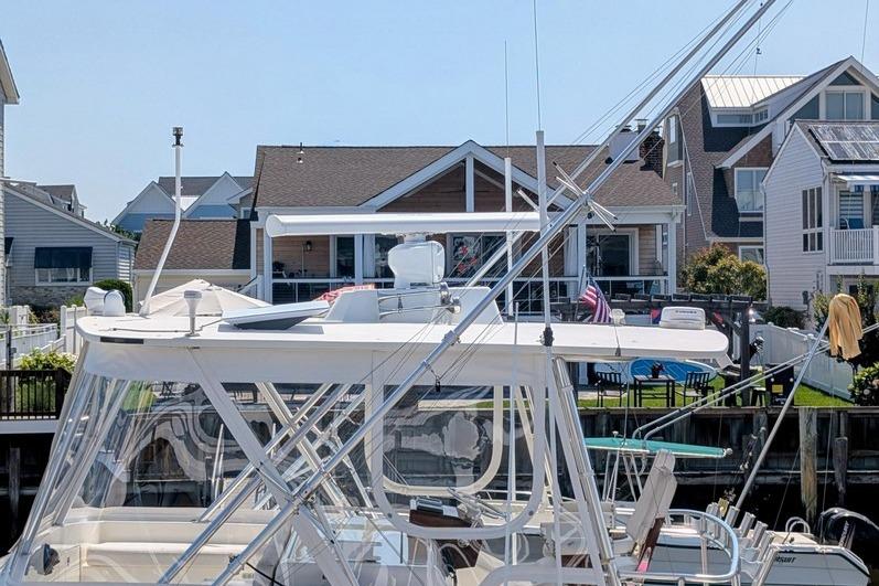 2005 Egg Harbor 43 SportYacht docked near waterfront homes.
