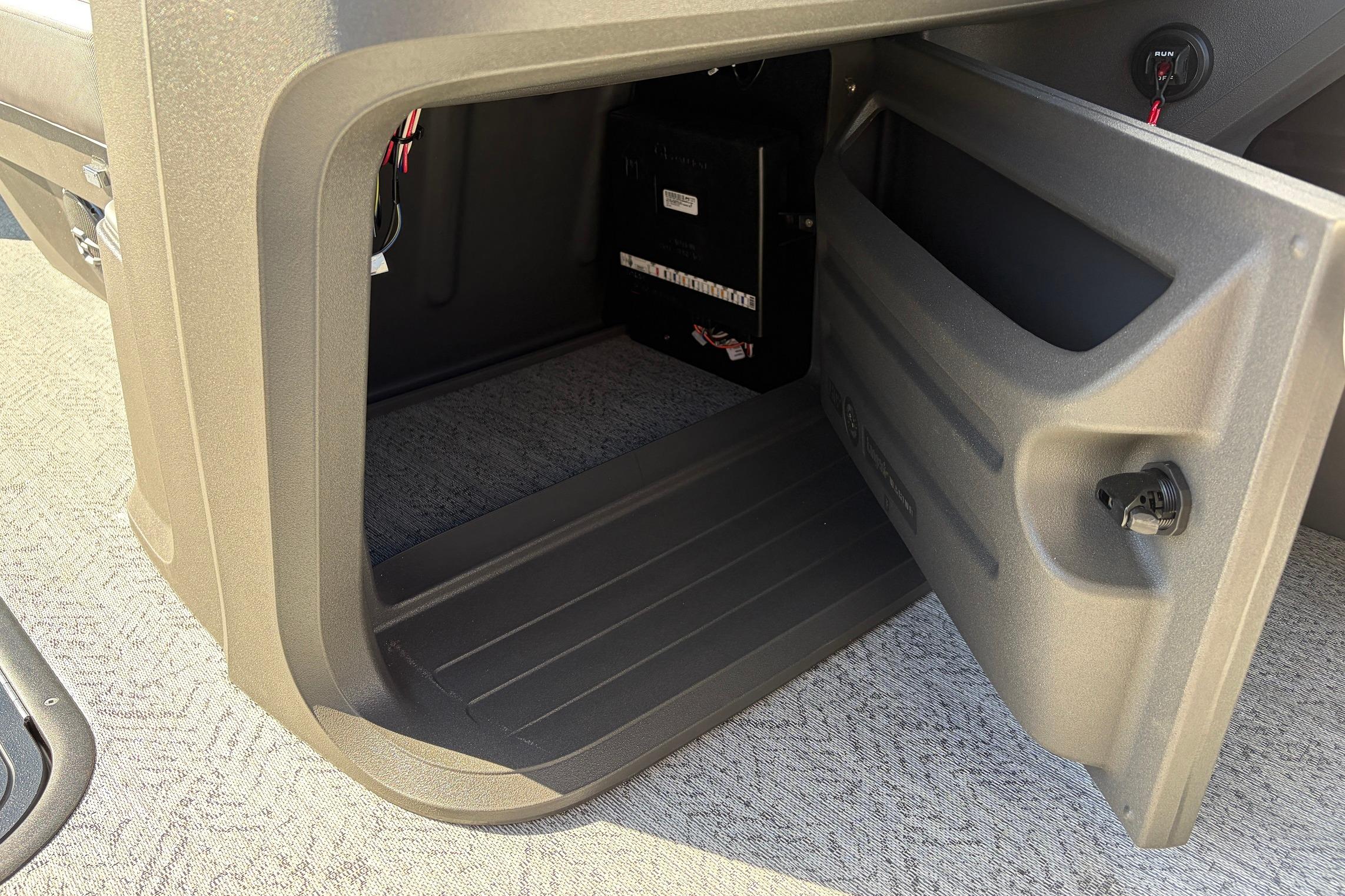 Open storage compartment in 2026 Sun Tracker Fishin' Barge 22 XP3 boat.