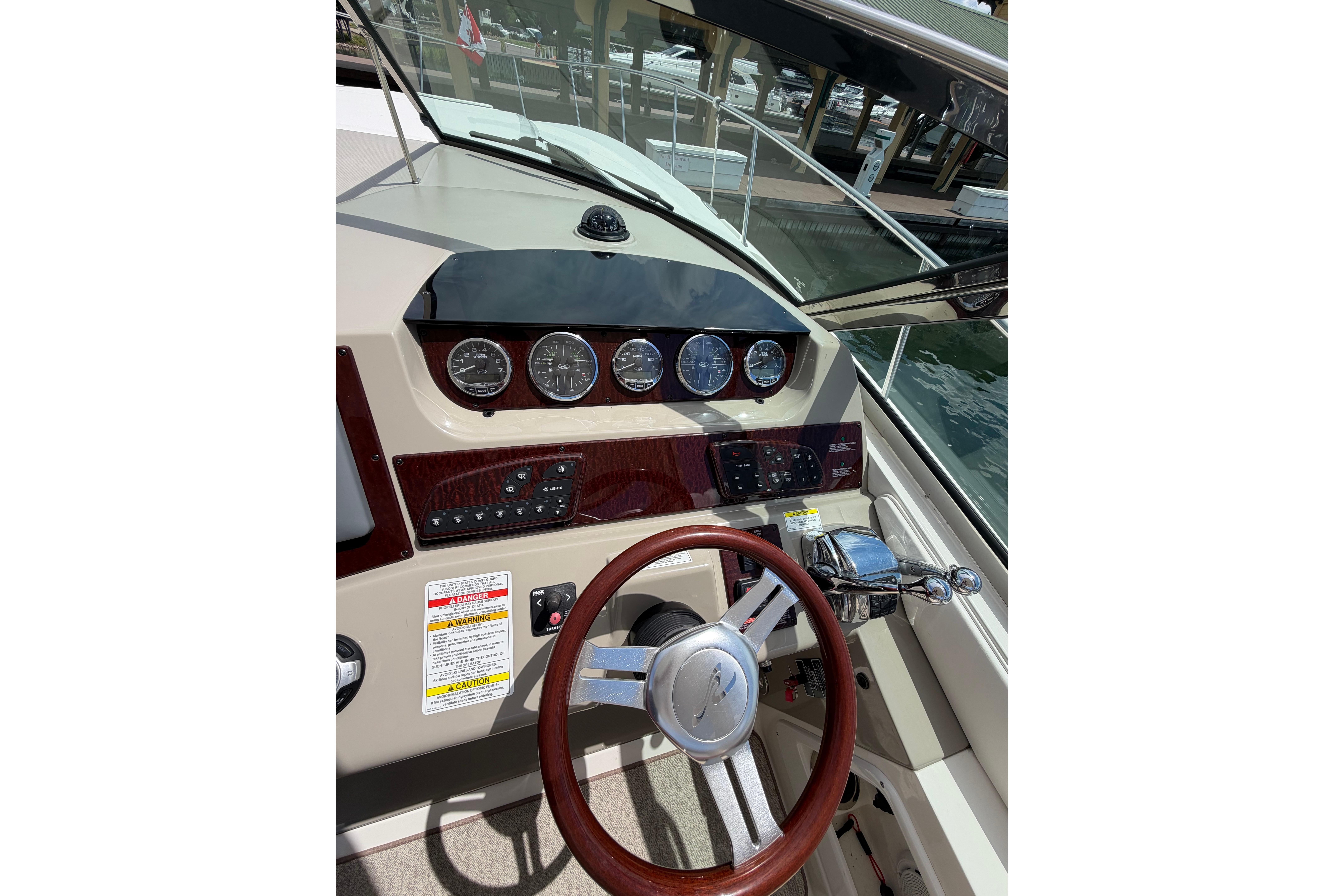 Helm of 2012 Sea Ray Sundancer 370 with gauges and wooden steering wheel.