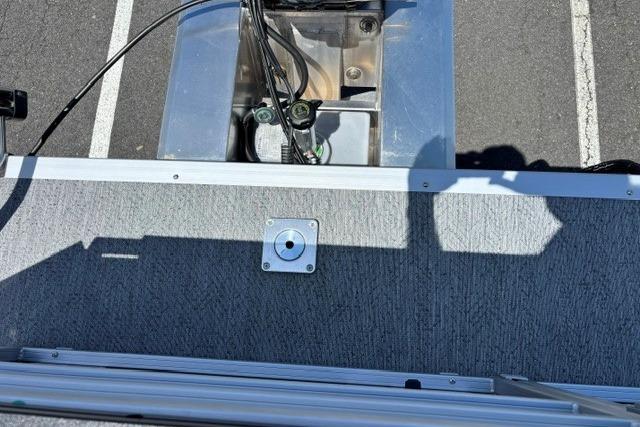 2026 Sun Tracker Fishin' Barge 20 DLX deck with visible wiring and metal components.