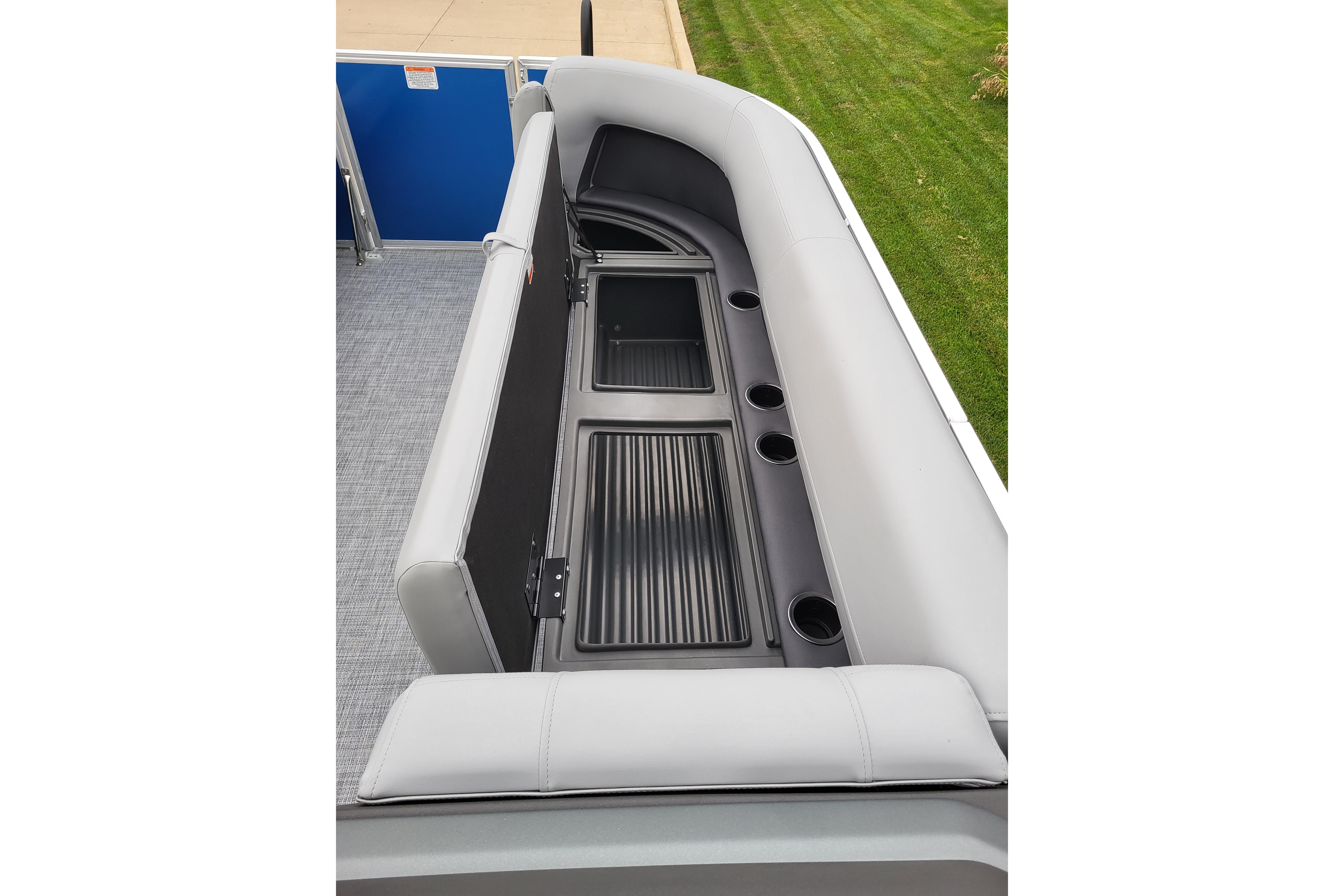 2026 Sun Tracker Party Barge 18 DLX interior seating with storage and cup holders.