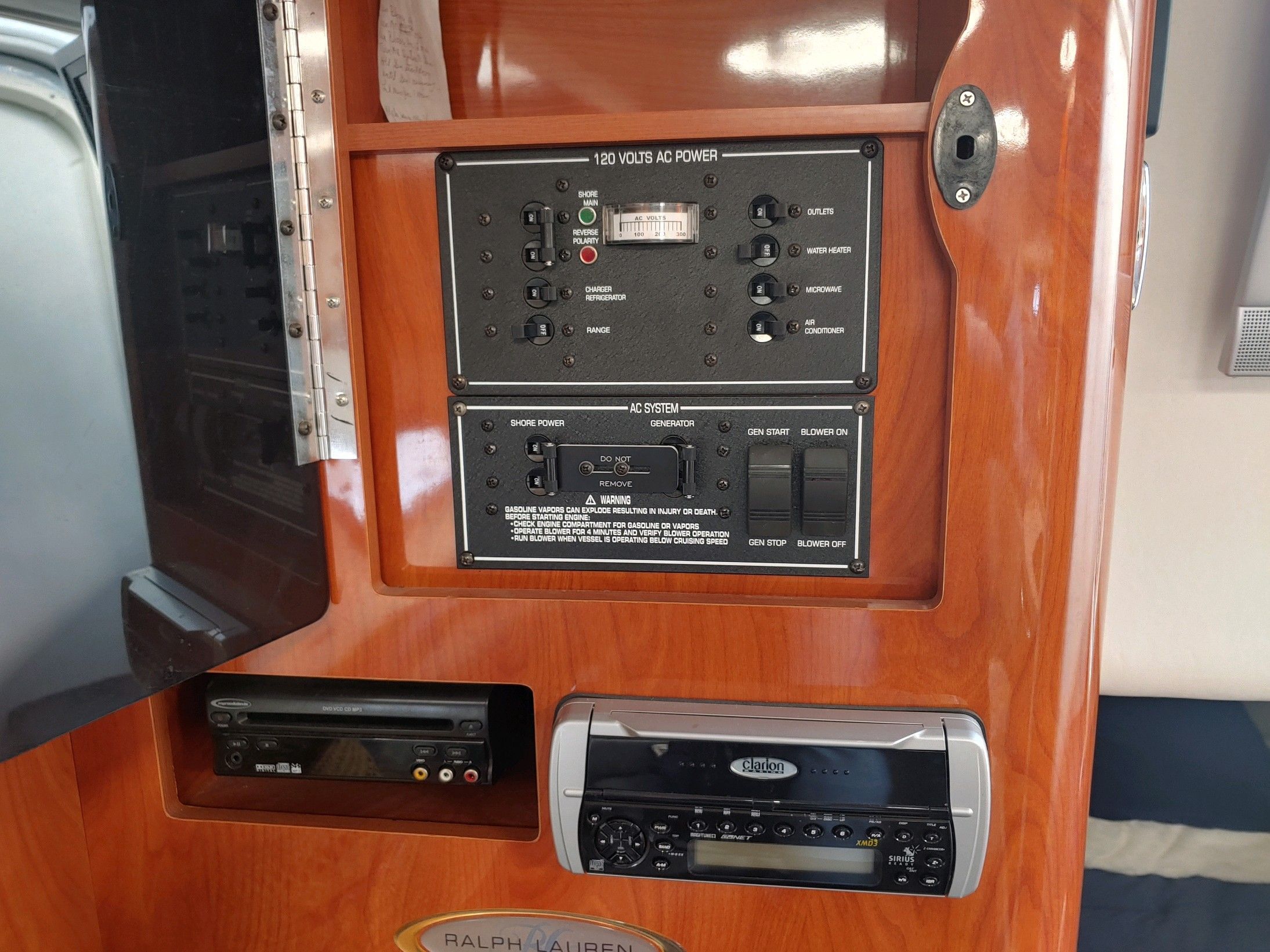 Interior view of a boat with control panel and stereo system.