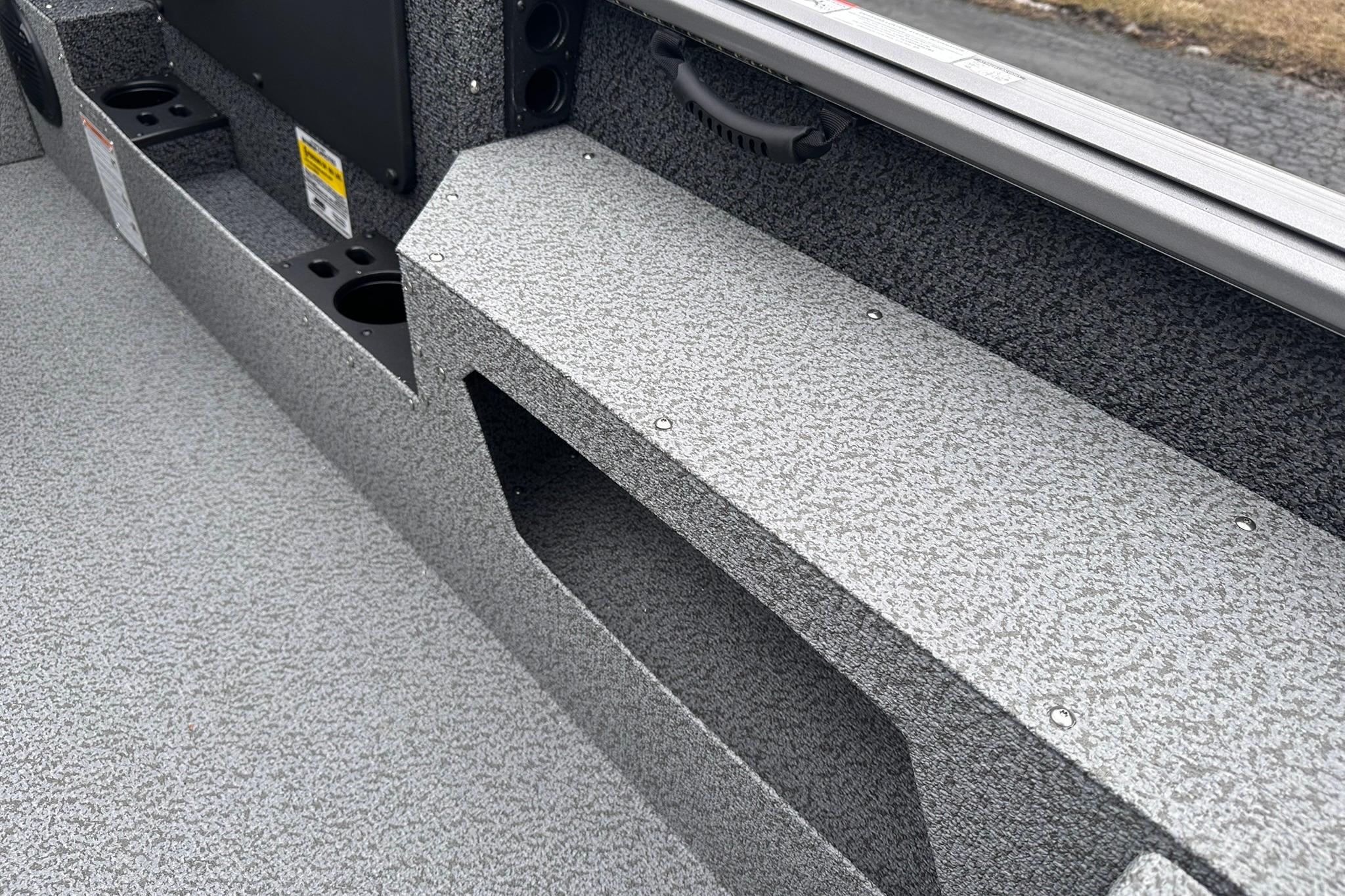 2026 Lund 1775 Impact XS Sport boat interior with textured flooring and storage compartments.