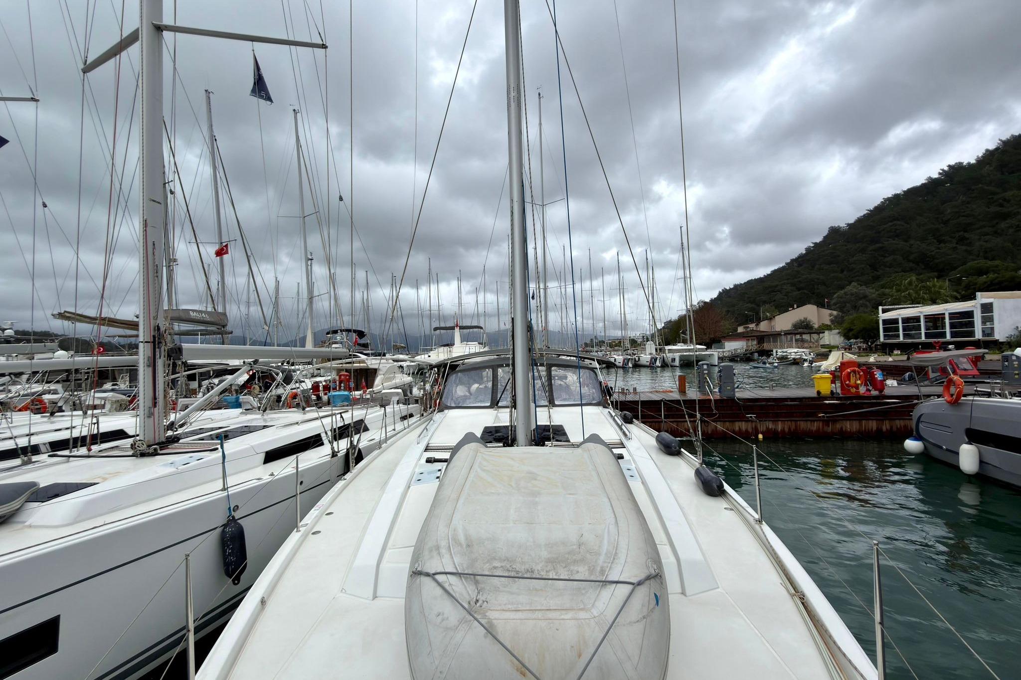 2024 Hanse 510 yacht docked in a marina under cloudy skies.