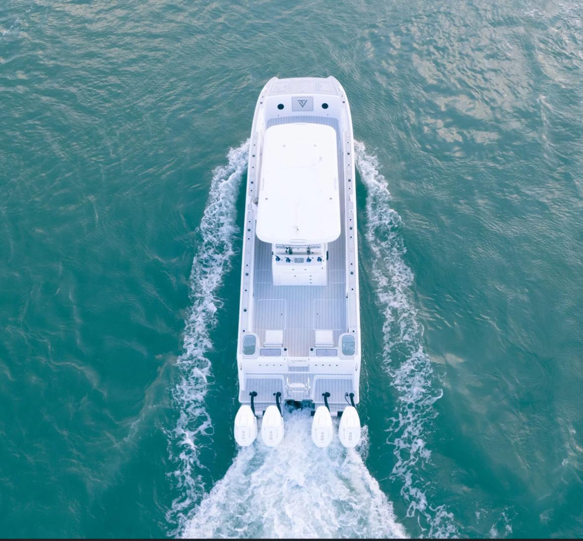 Aerial view of 2025 Twin Vee 400 GFX boat cruising on water.