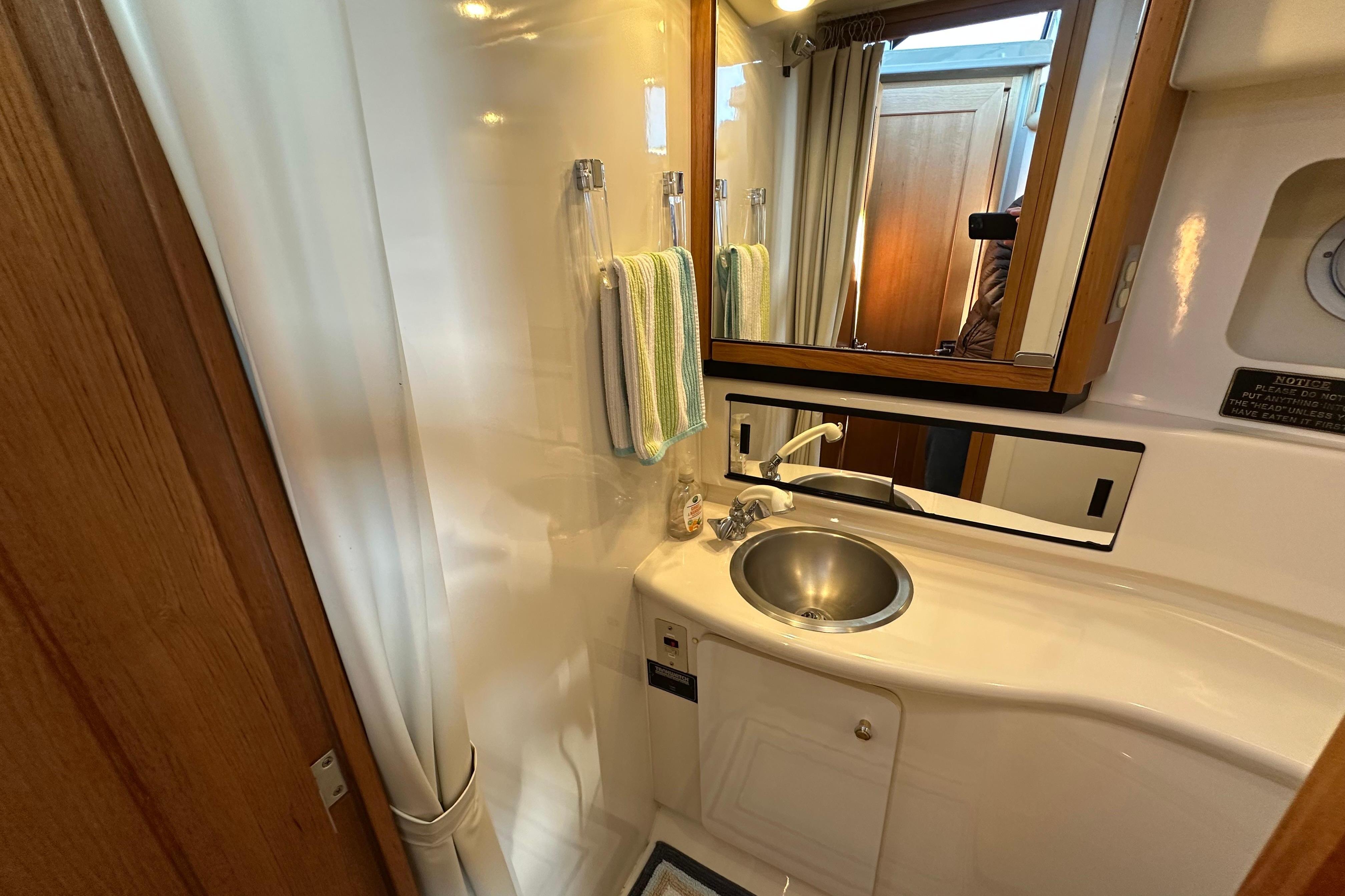 Bathroom interior of 2000 Bayliner 4087 Aft Cabin Motoryacht with sink and mirror.
