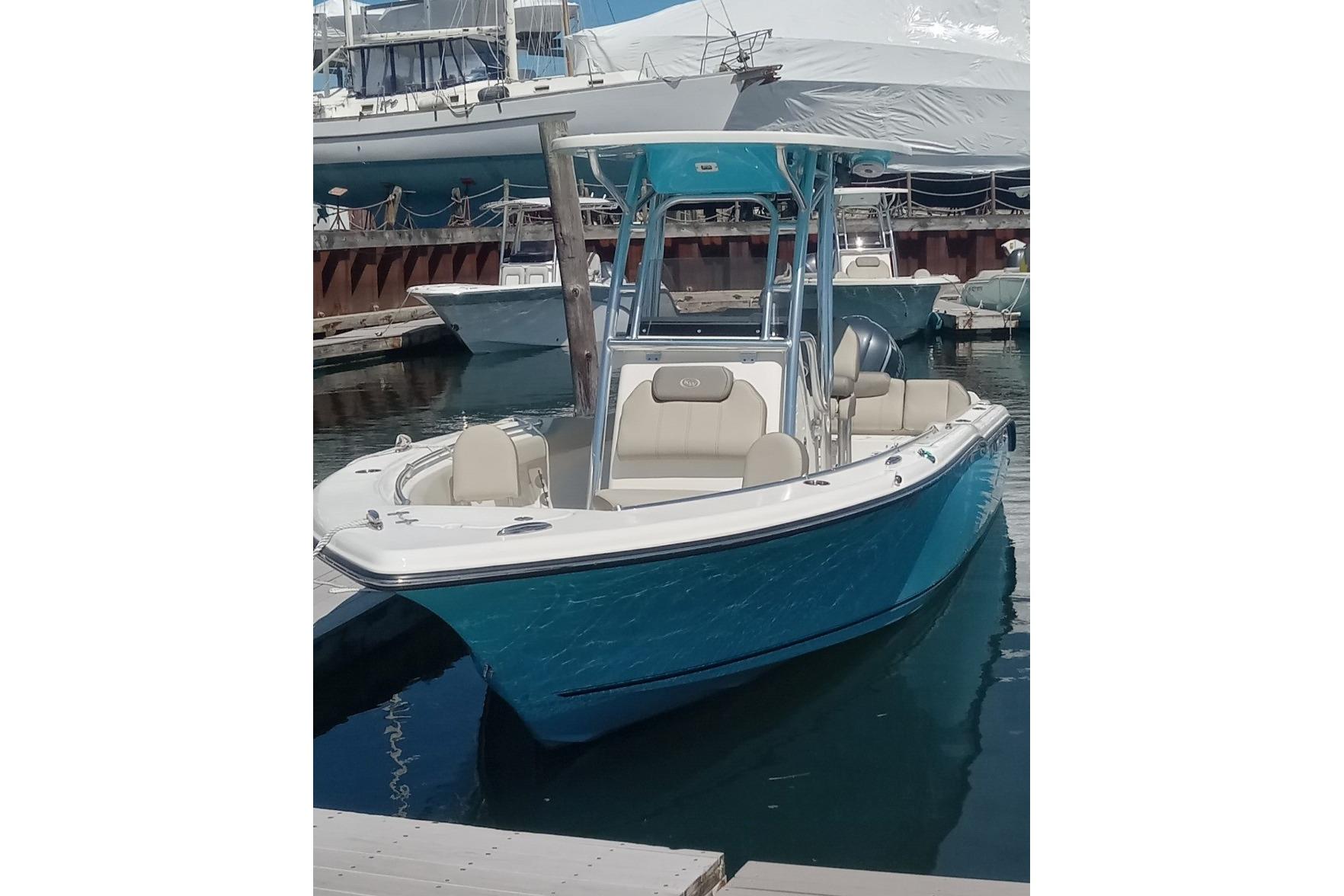 2024 Key West 239 FS boat docked, featuring a sleek blue hull and modern design.