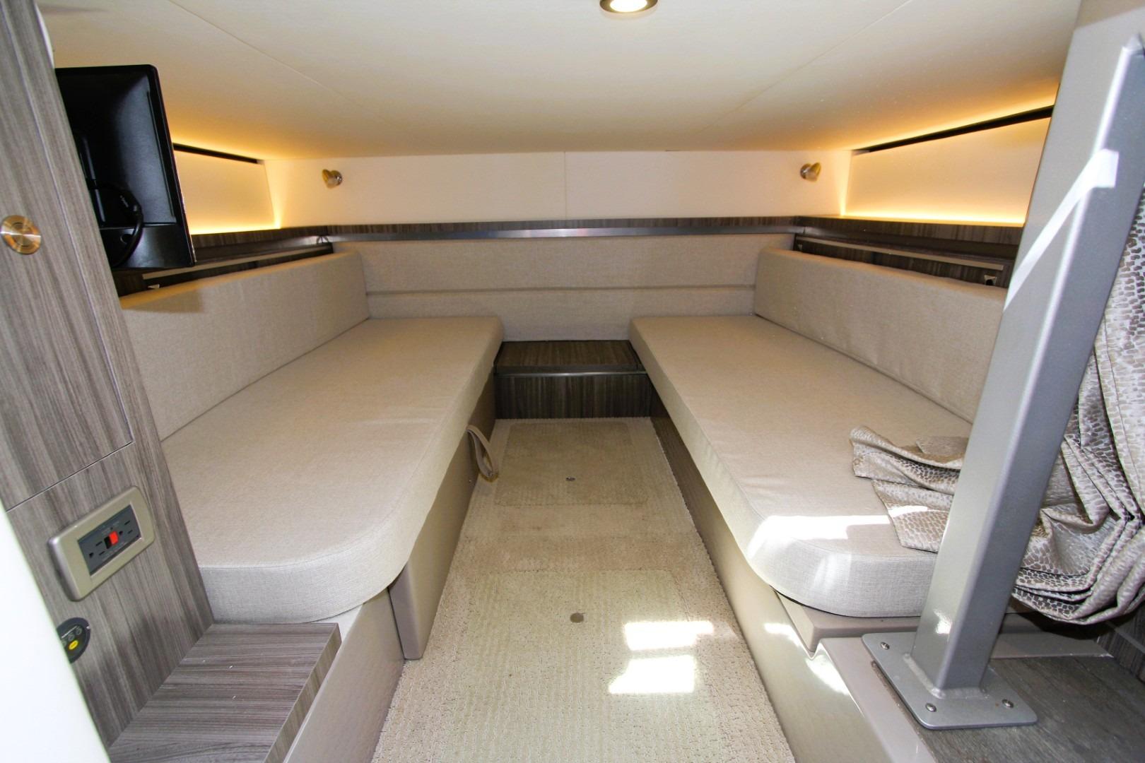 Interior cabin of 2021 Sea Ray Sundancer 320 Outboard with beige seating and modern design.