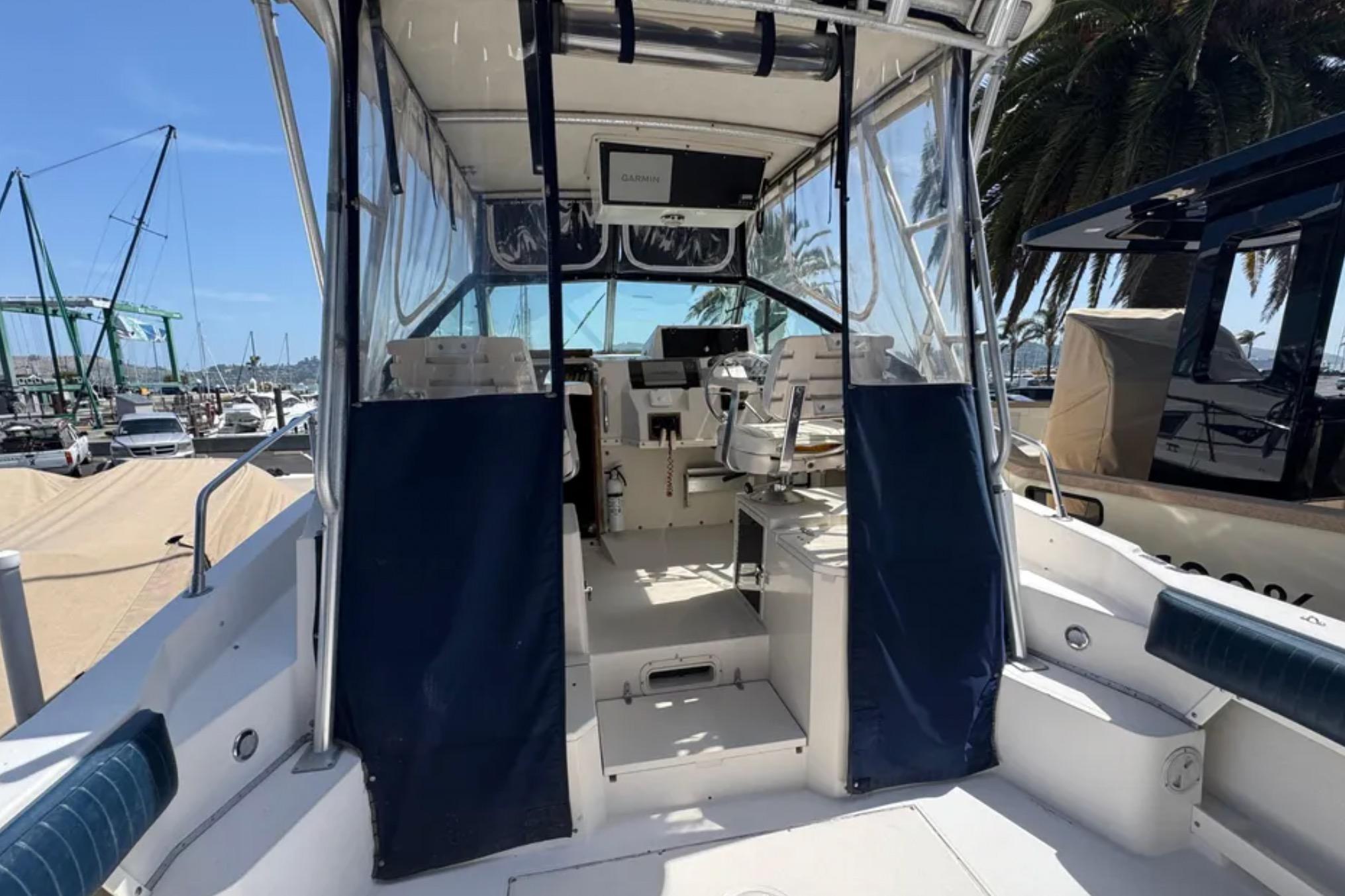 1990 Grady-White Marlin 280 boat interior with helm, docked at marina.