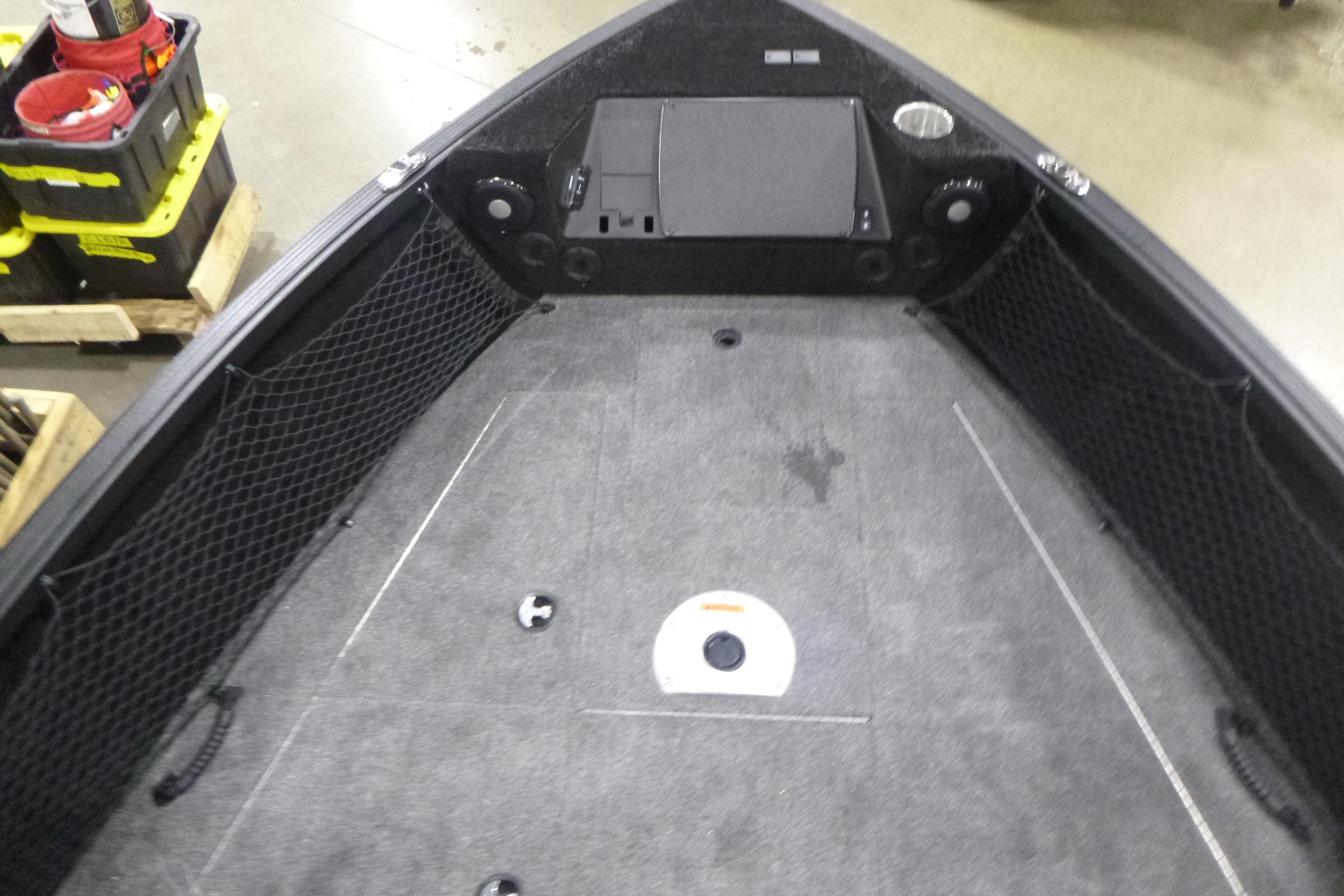 2026 Alumacraft Trophy 205X Sport boat interior with storage nets and carpeted deck.