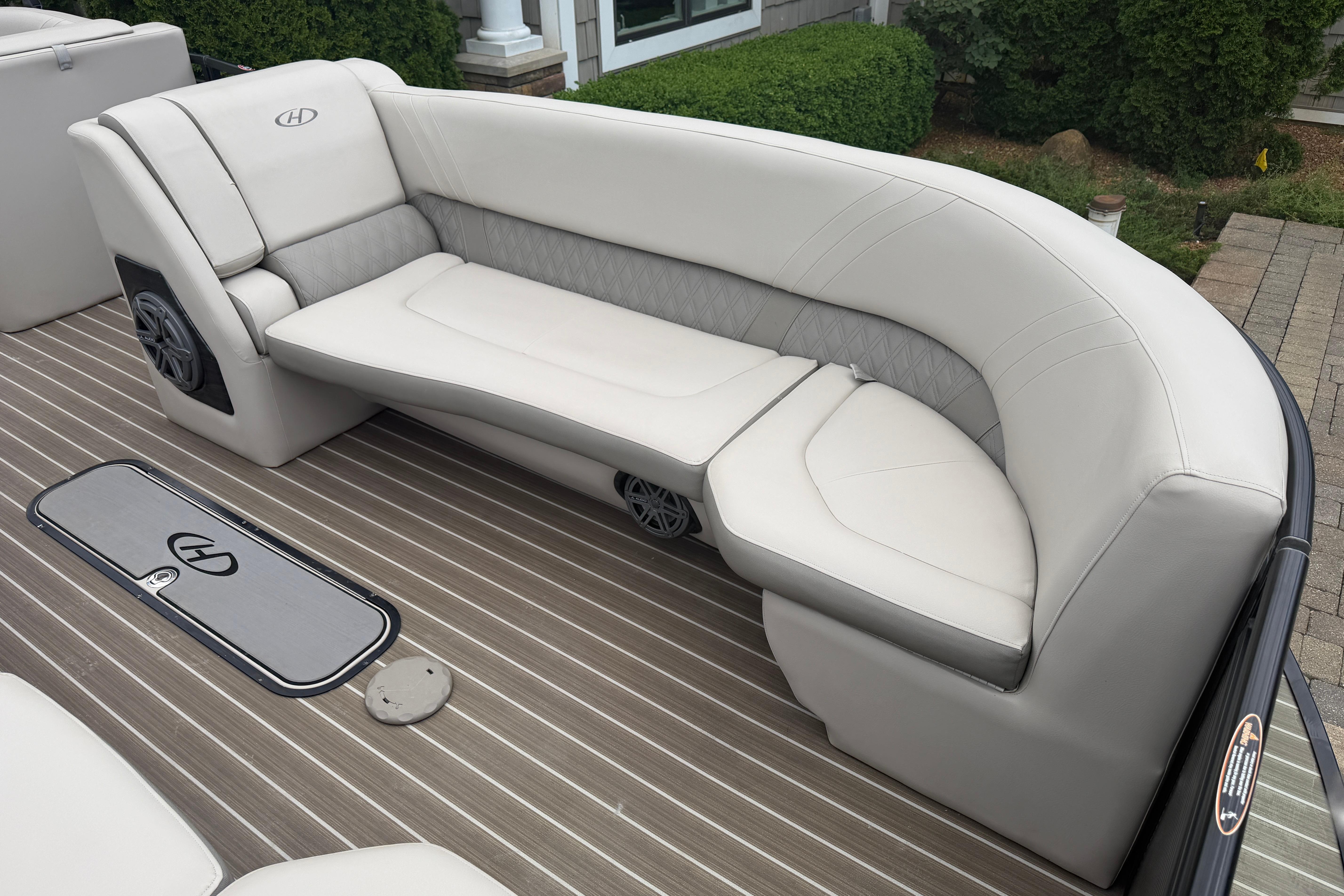 2019 Harris Solstice 240 boat interior with elegant white seating and striped flooring.
