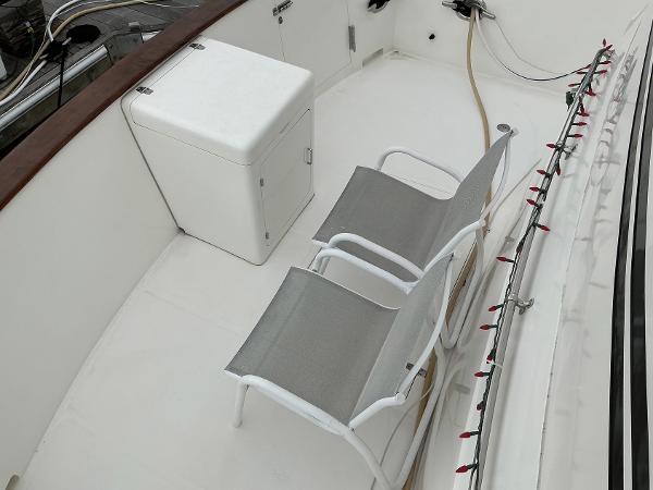 Deck of 2000 Novatec Islander 55 with chairs and storage box.