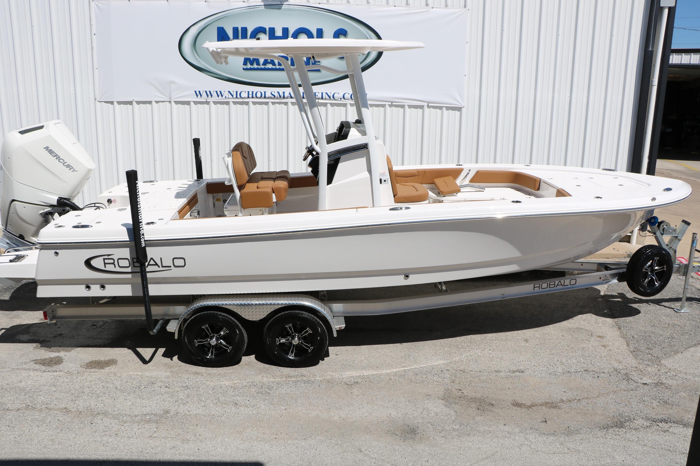 2026 Robalo 246 Cayman boat on trailer, displayed outdoors at dealership.