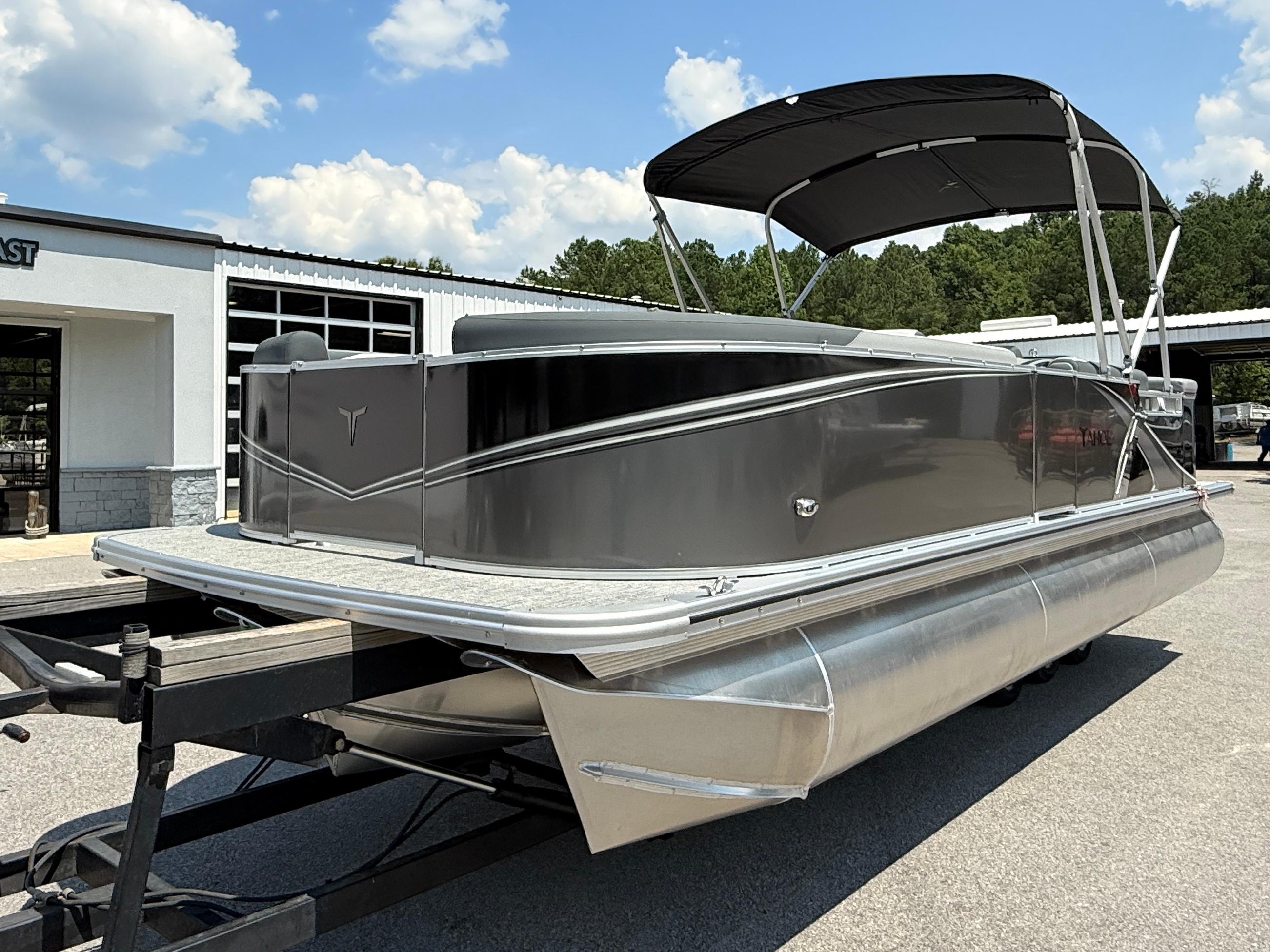 2025 Tahoe Pontoon LTZ Cruise boat with canopy on trailer, parked outdoors.
