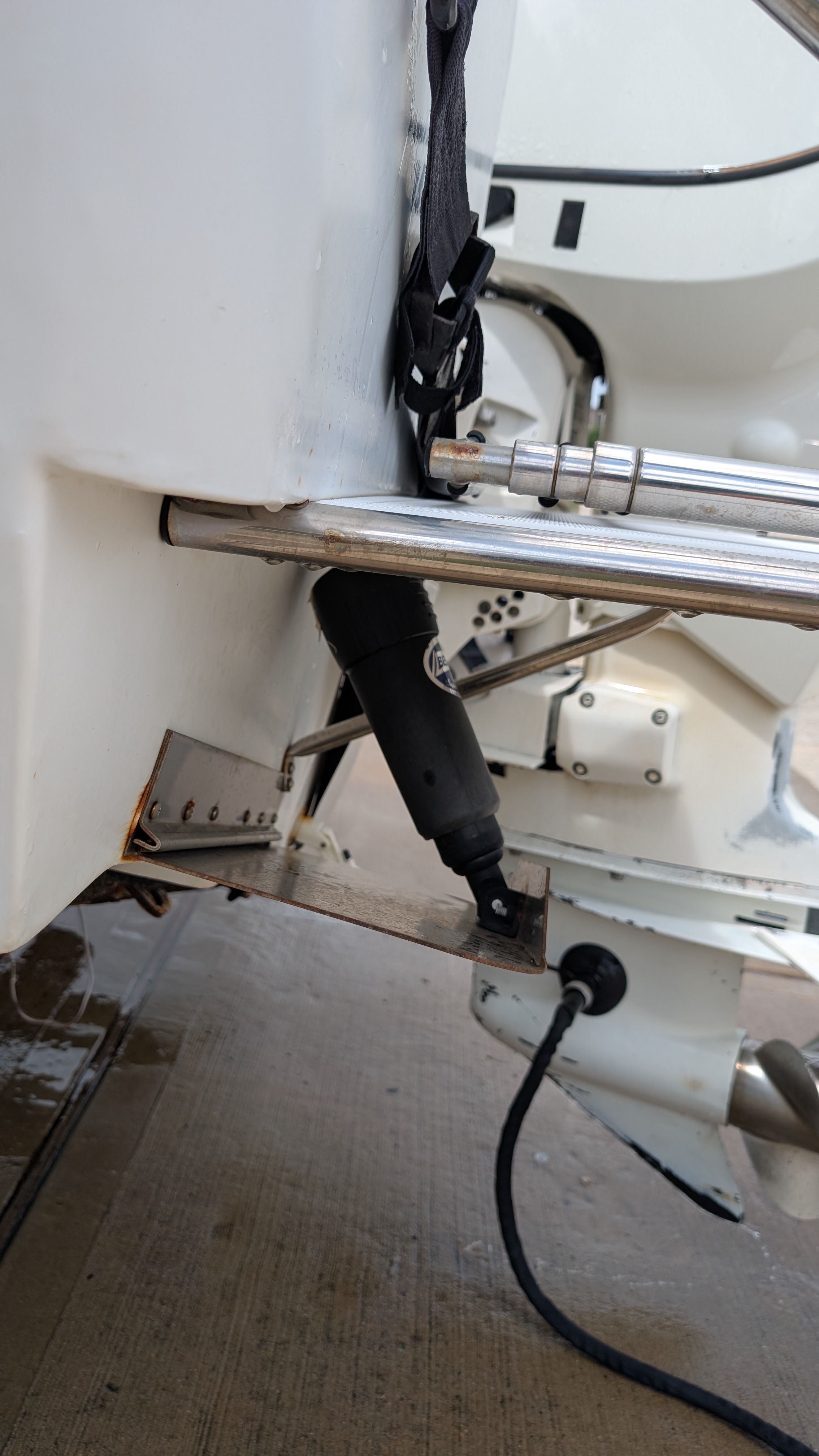 Close-up of the stern of a 2007 Triumph 215 CC boat with motor and metal railing.
