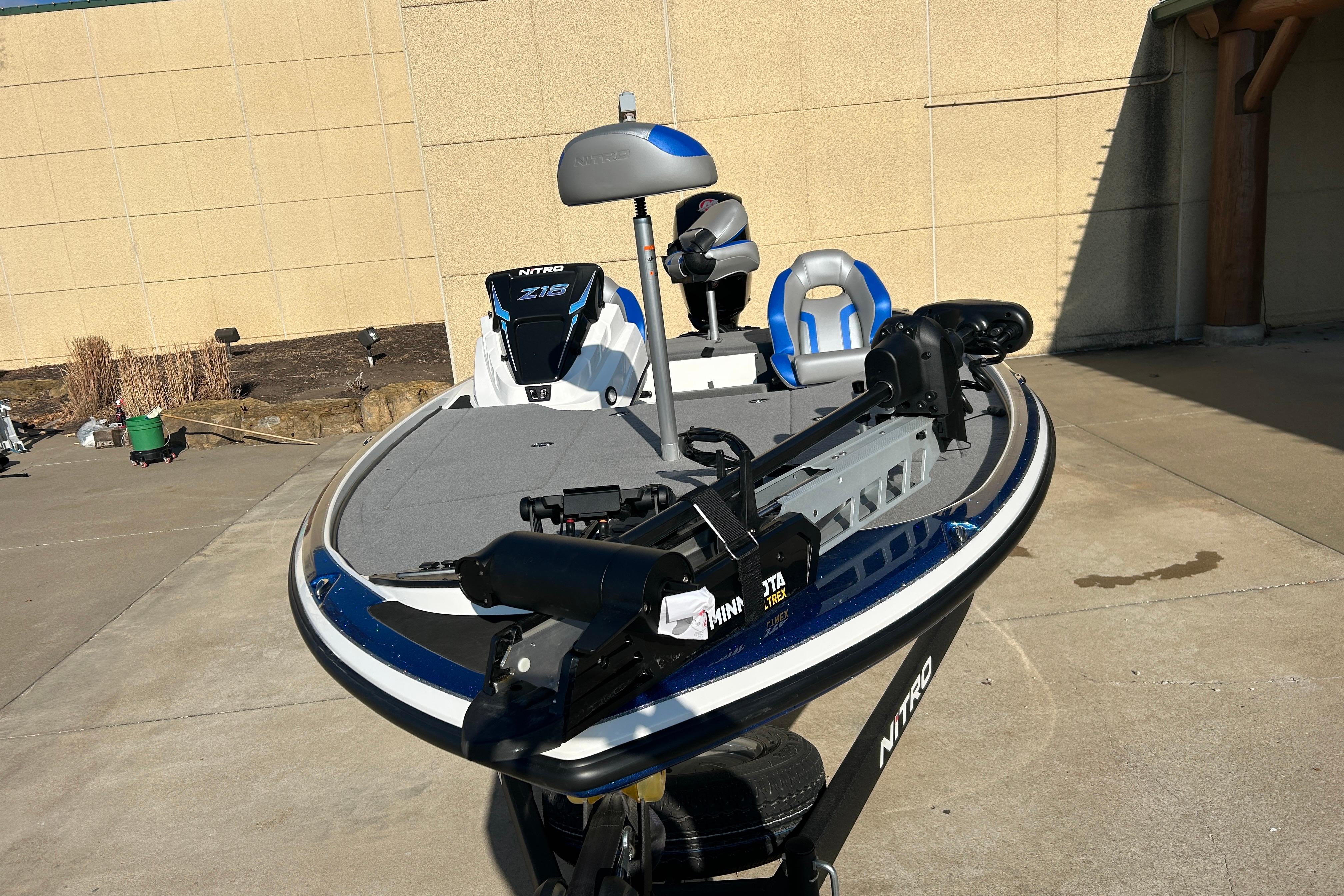 2025 Nitro Z18 Pro fishing boat with Minn Kota trolling motor, parked outdoors.