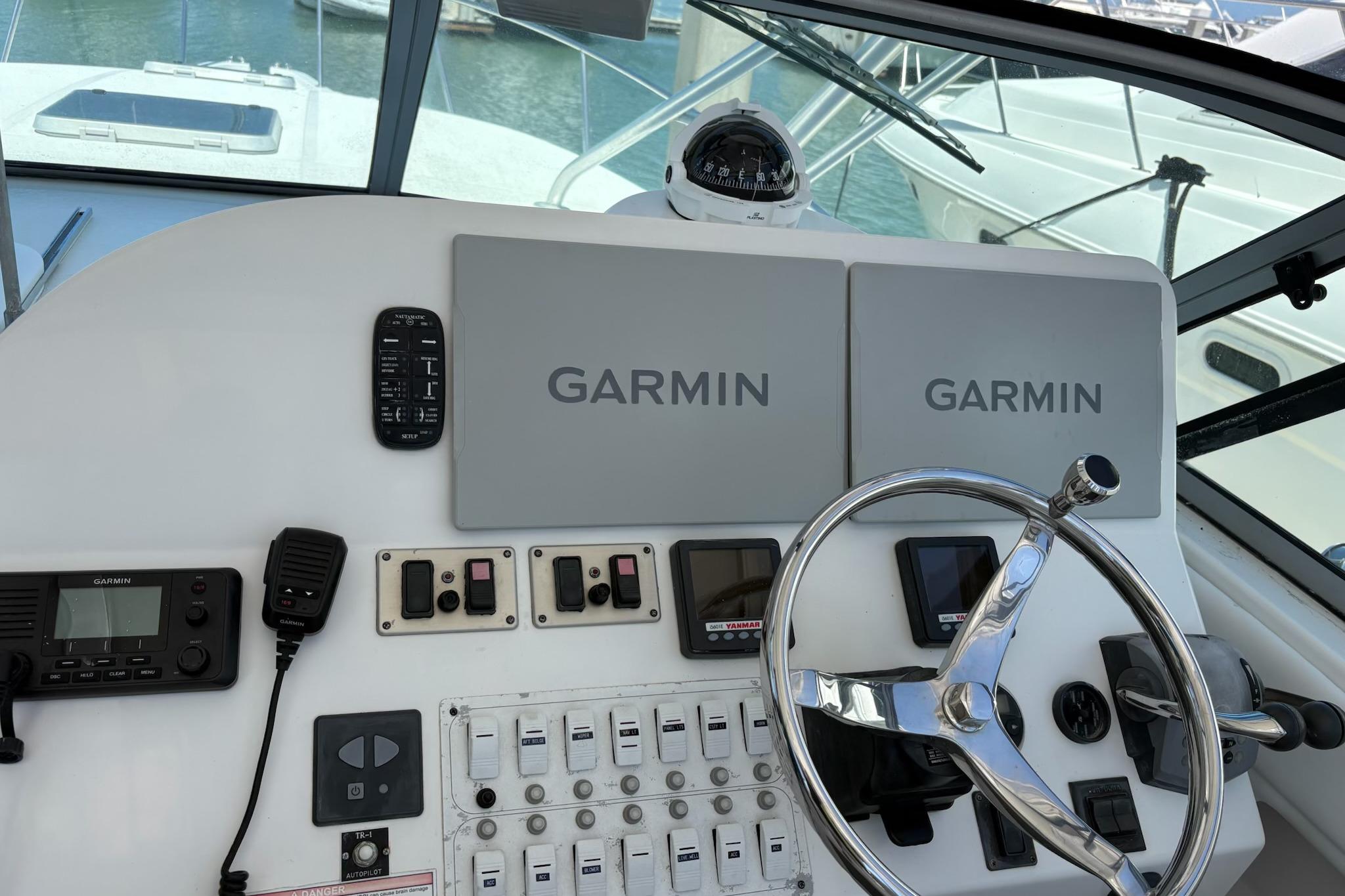Helm of 2008 Stamas 370 Express with Garmin navigation systems and steering wheel.