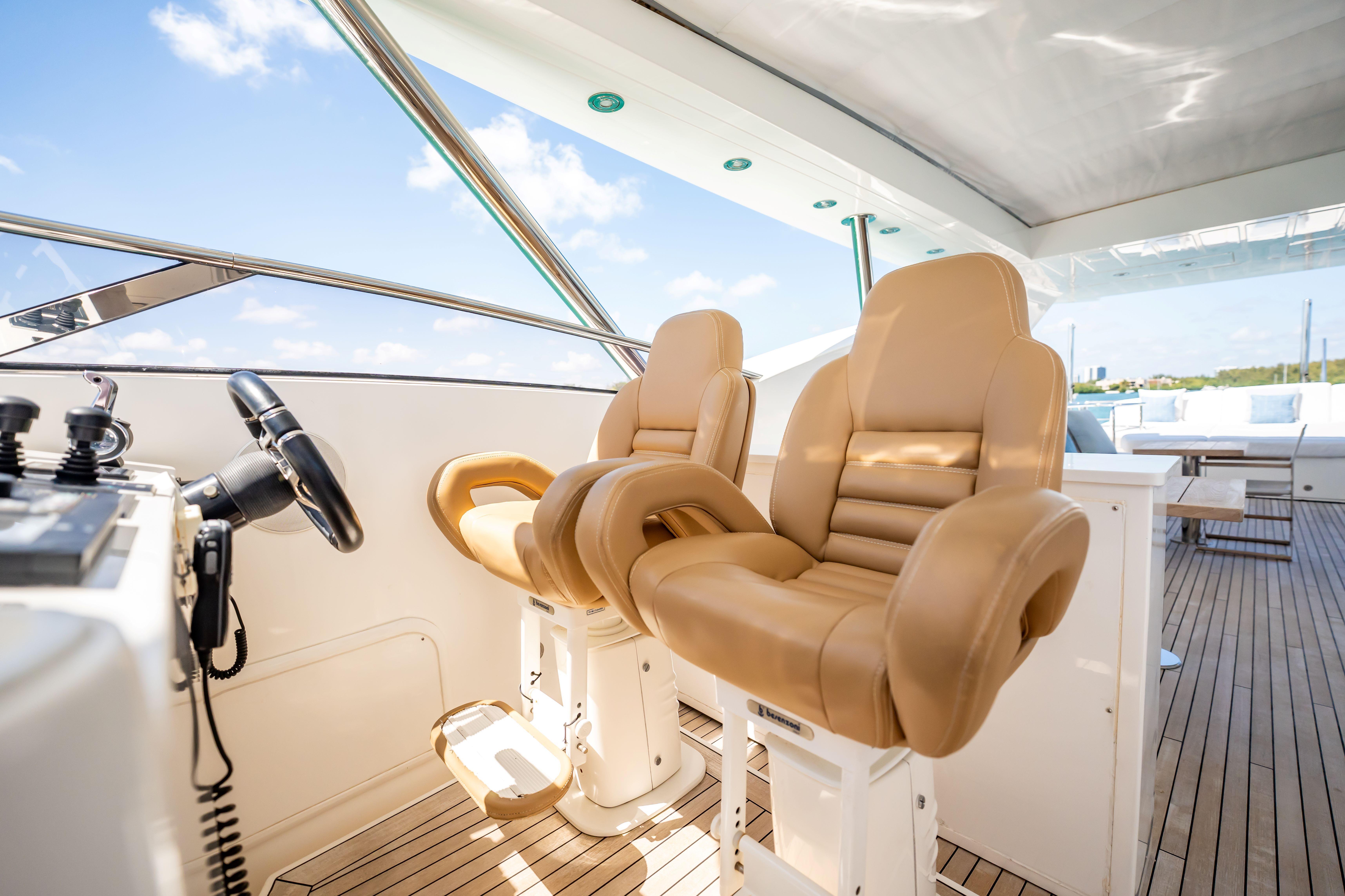 Luxurious helm seats on a 2011 Sunseeker 34 Metre Yacht, showcasing elegant design and comfort.