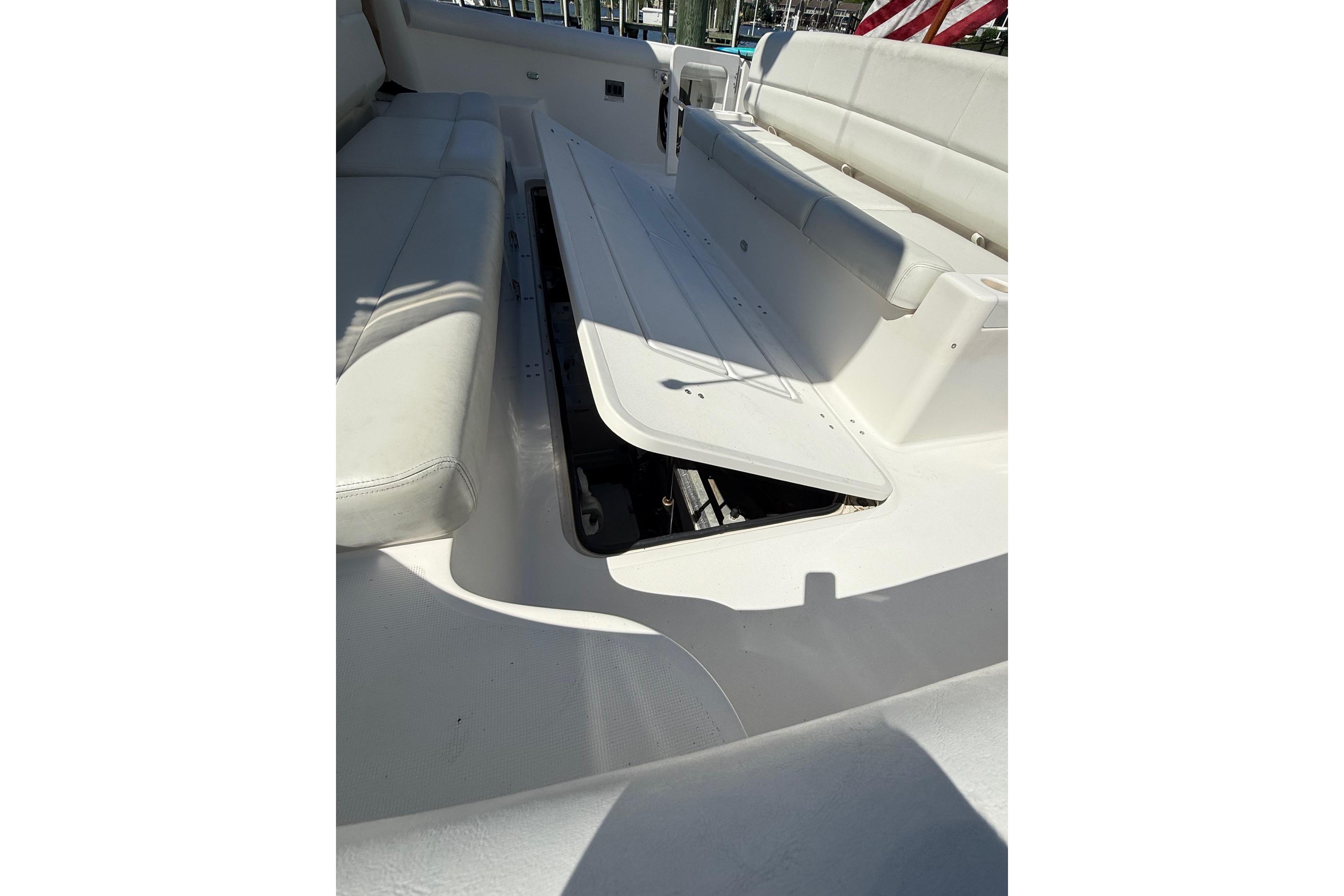 2001 Tiara Yachts 5200 Express interior seating with storage compartment open.