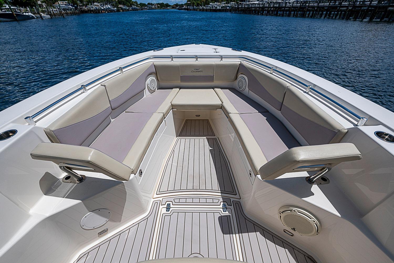 2019 Cobia 320 Center Console boat with spacious seating and elegant design on calm water.