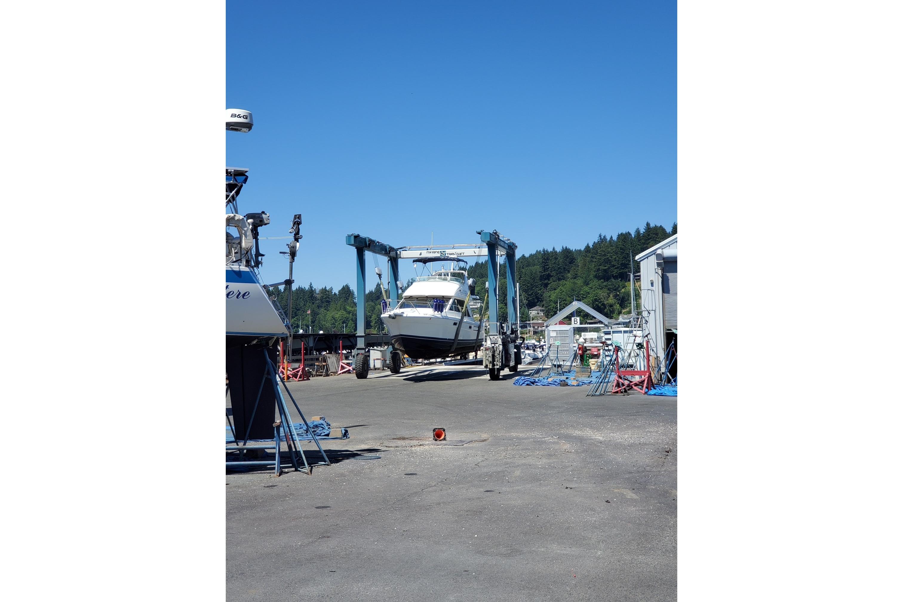 1998 Bayliner 3388 Command Bridge Motoryacht being transported at a marina.