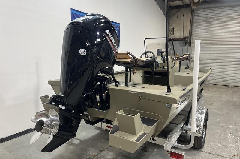 2025 SeaArk Shadow 18T boat with Mercury outboard motor in a garage setting.