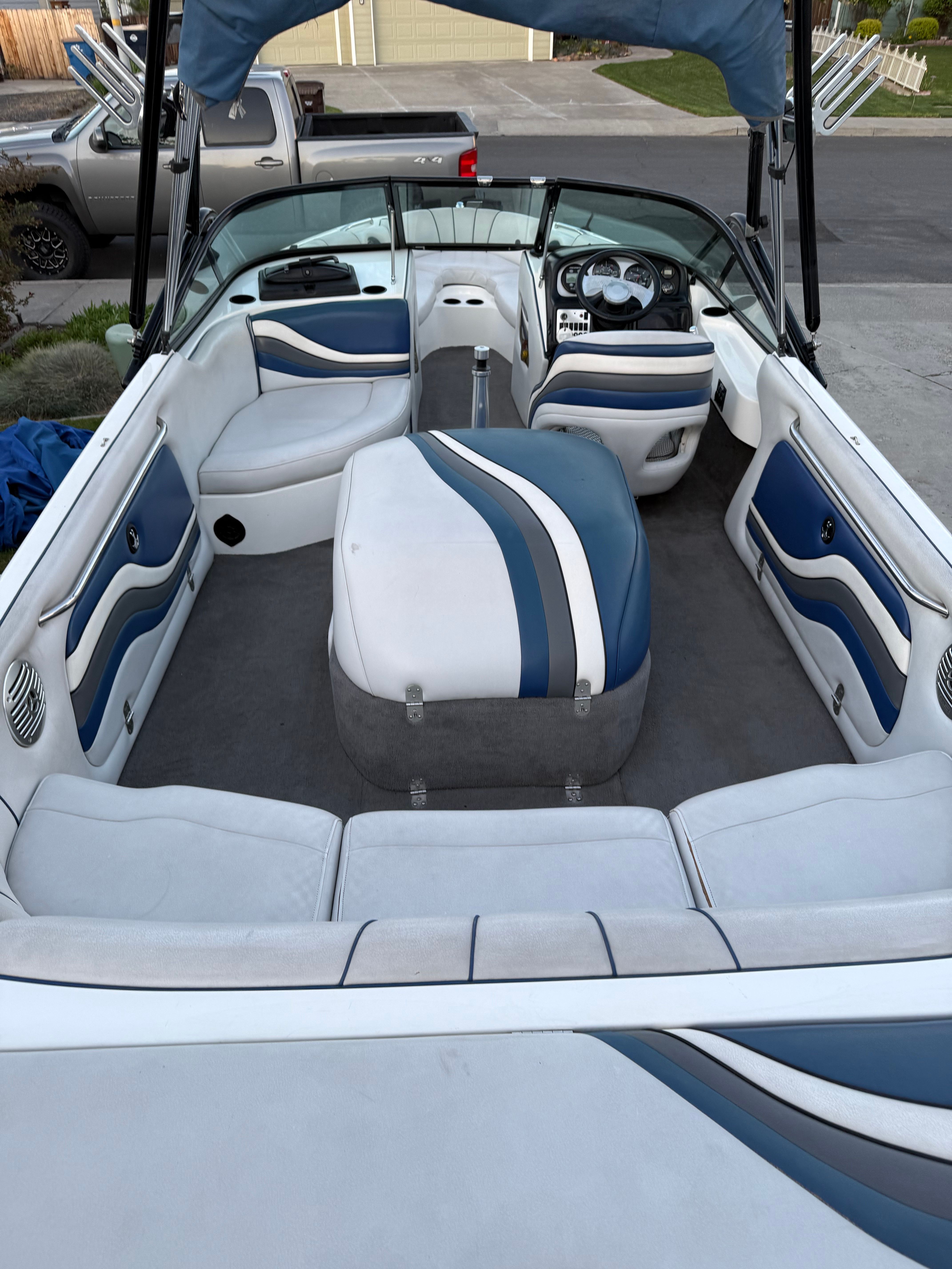 Interior of a 2004 MB Sports 220 boat with blue and white seating.